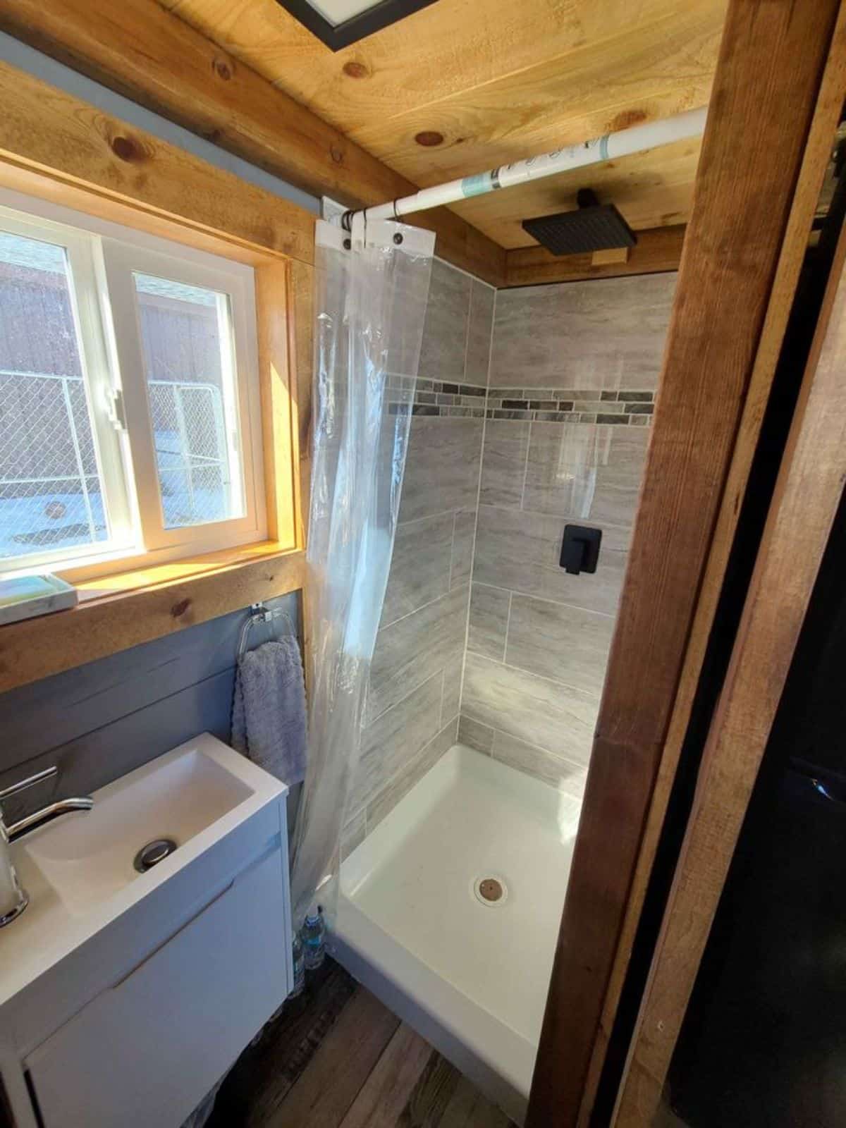 Separate shower area of 21' Display Model Tiny Home