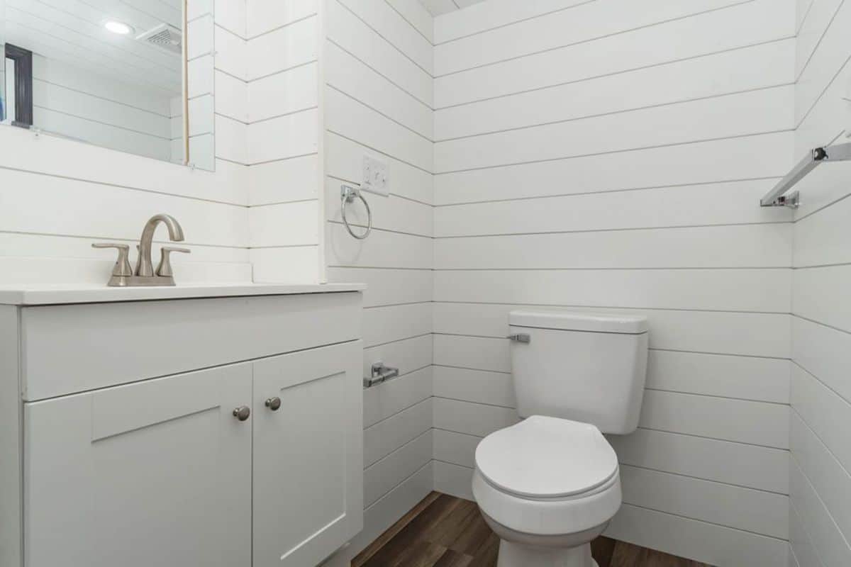 White tiled bathroom of brand new tiny house