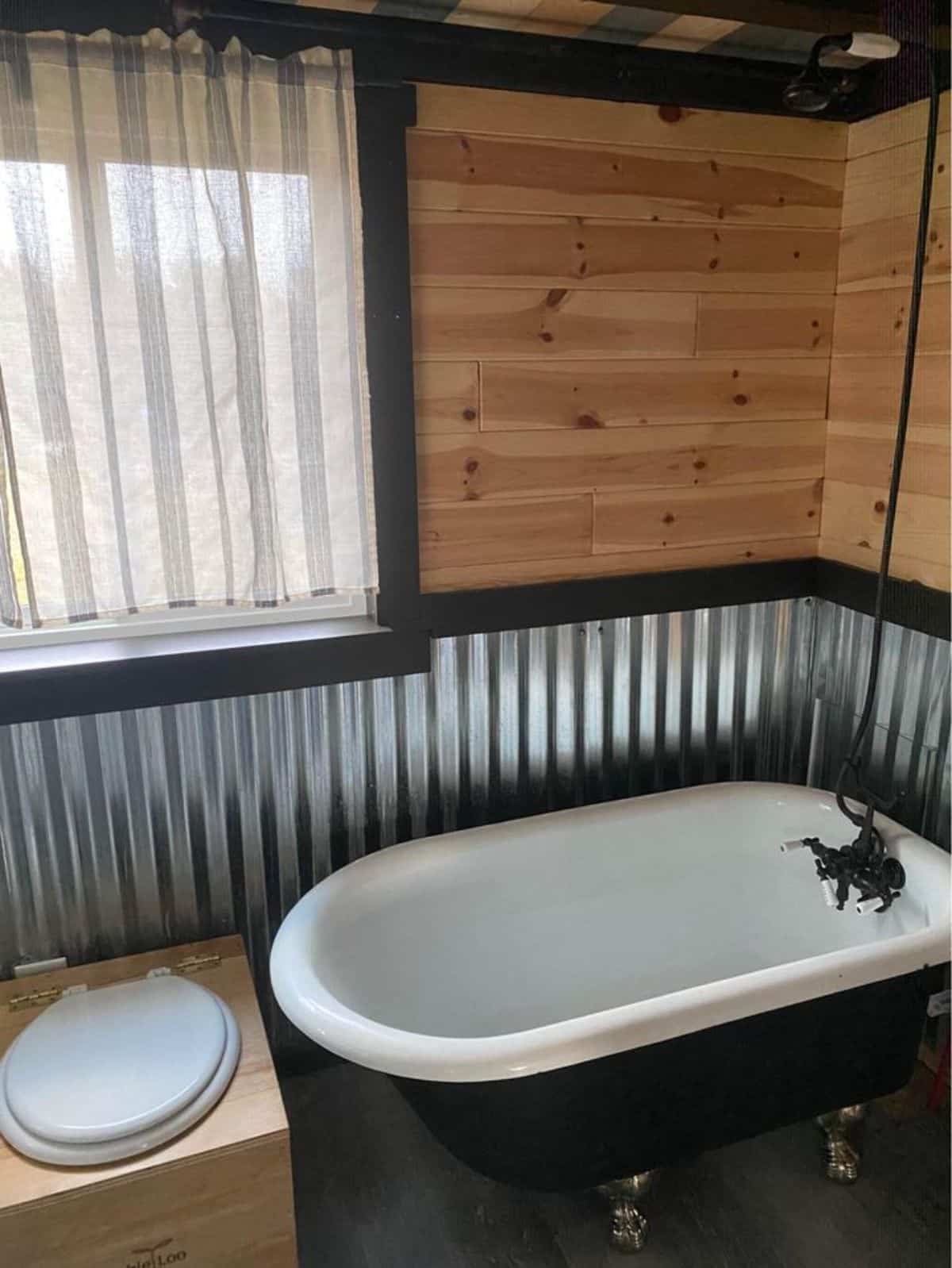 Claw foot tub in bathroom of 24' Cozy Tiny House
