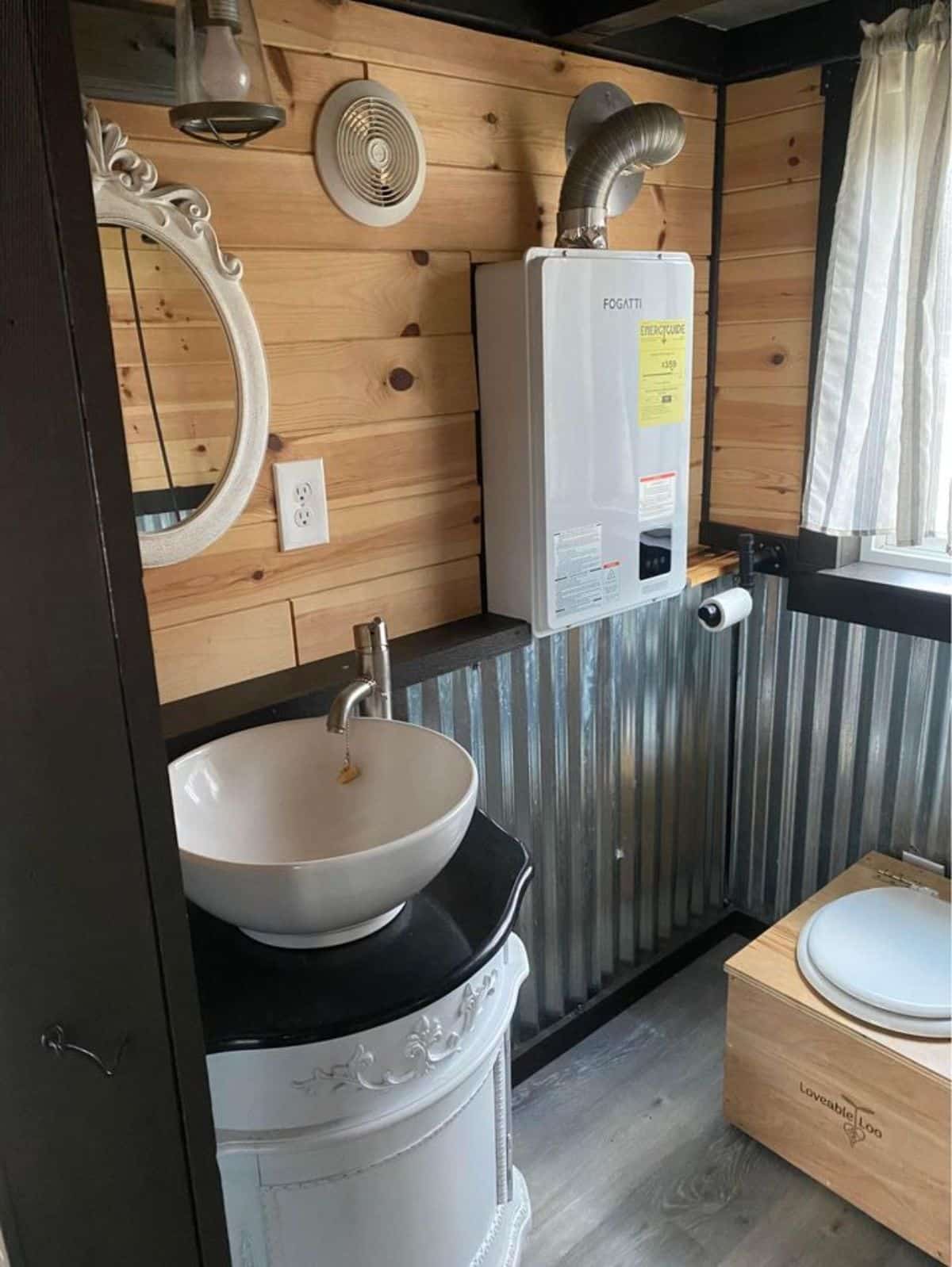Composting toilet with sink in bathroom
