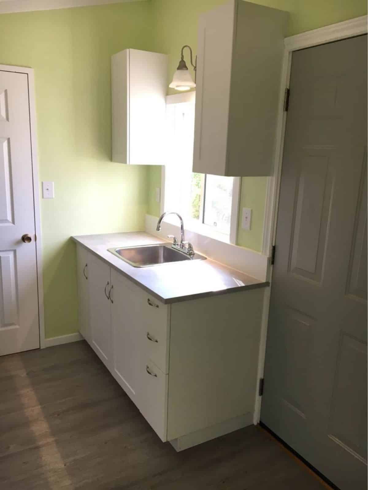 Stainless steel sink with storage cabinets
