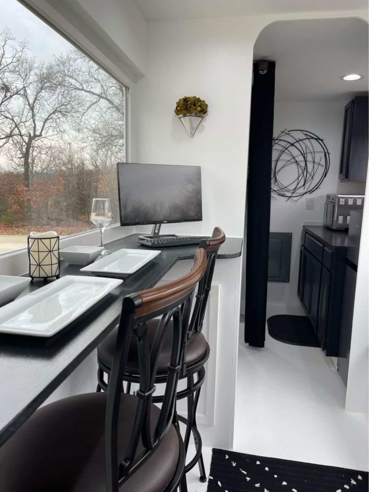 Huge window of with a view on dinning area of ultra affordable tiny home