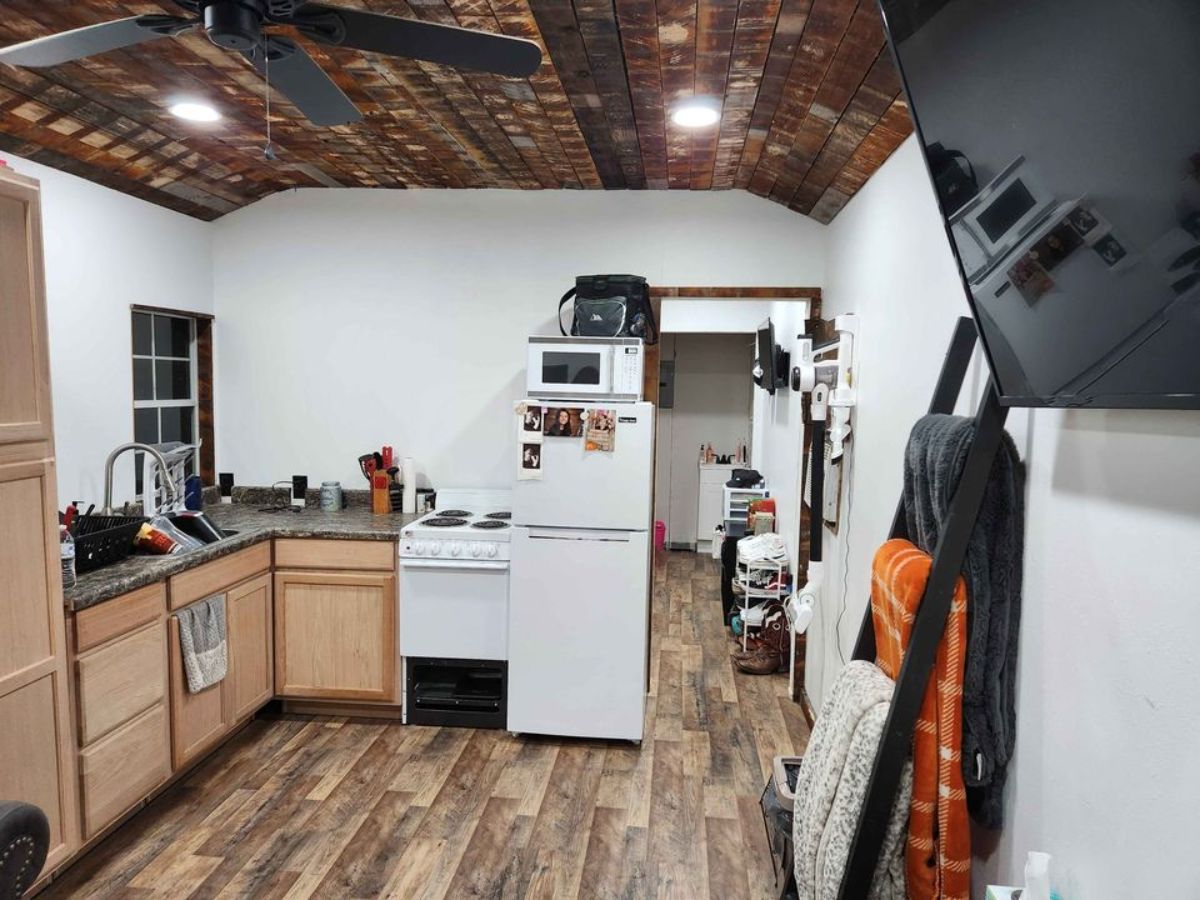 Stunning interiors with all the furniture and appliances of tiny home with downstairs bedroom