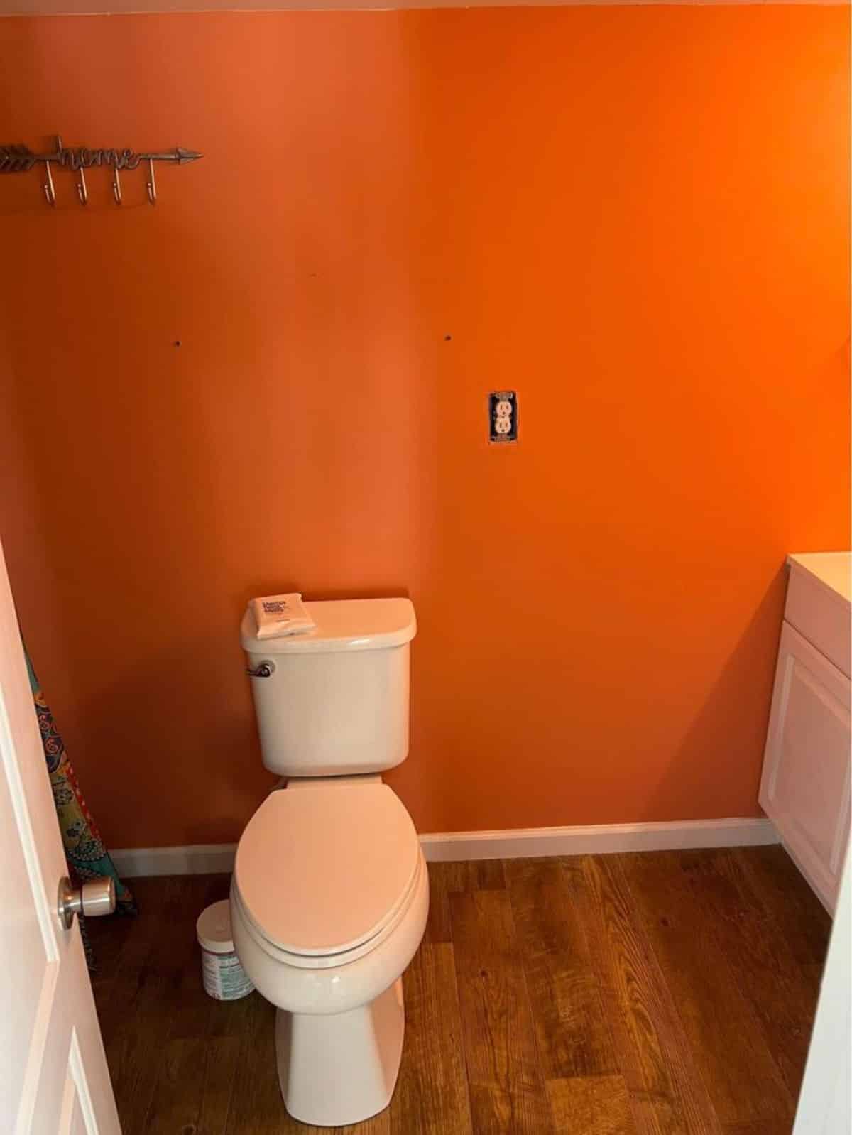 Standard toilet with flush in bathroom