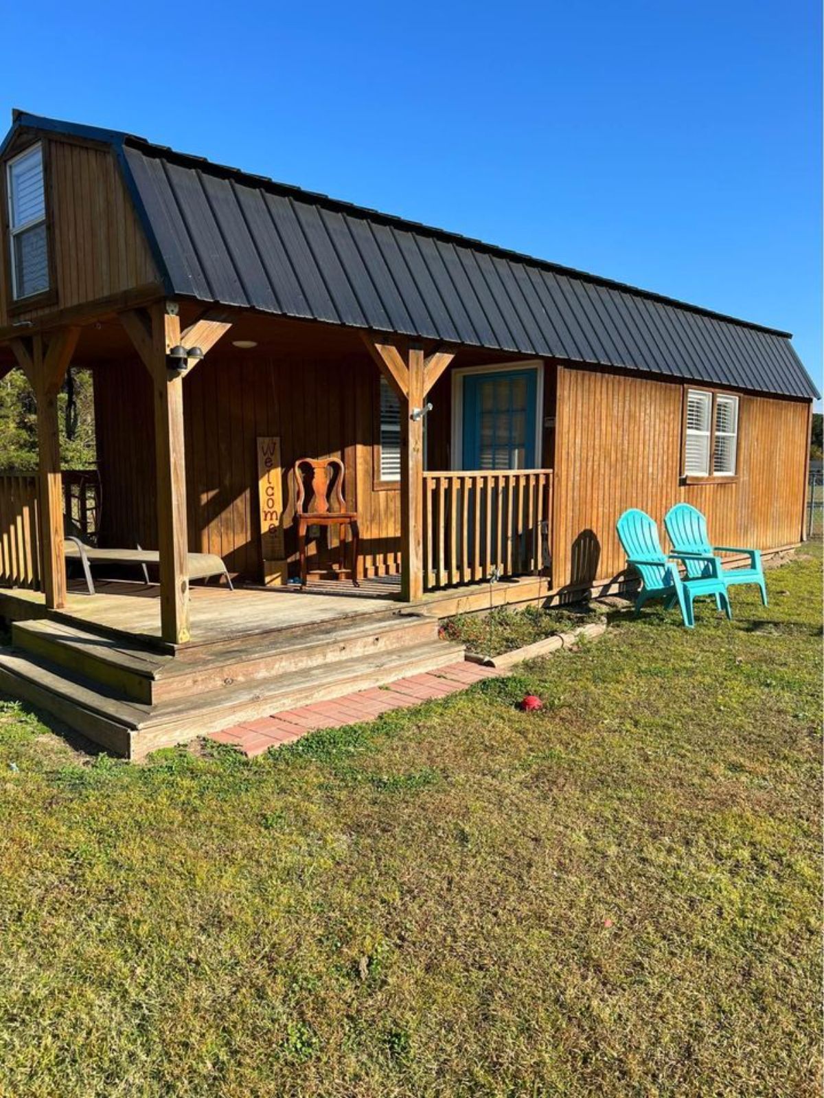 Main entrance with huge porch outside of 32-footed Shed Tiny Home