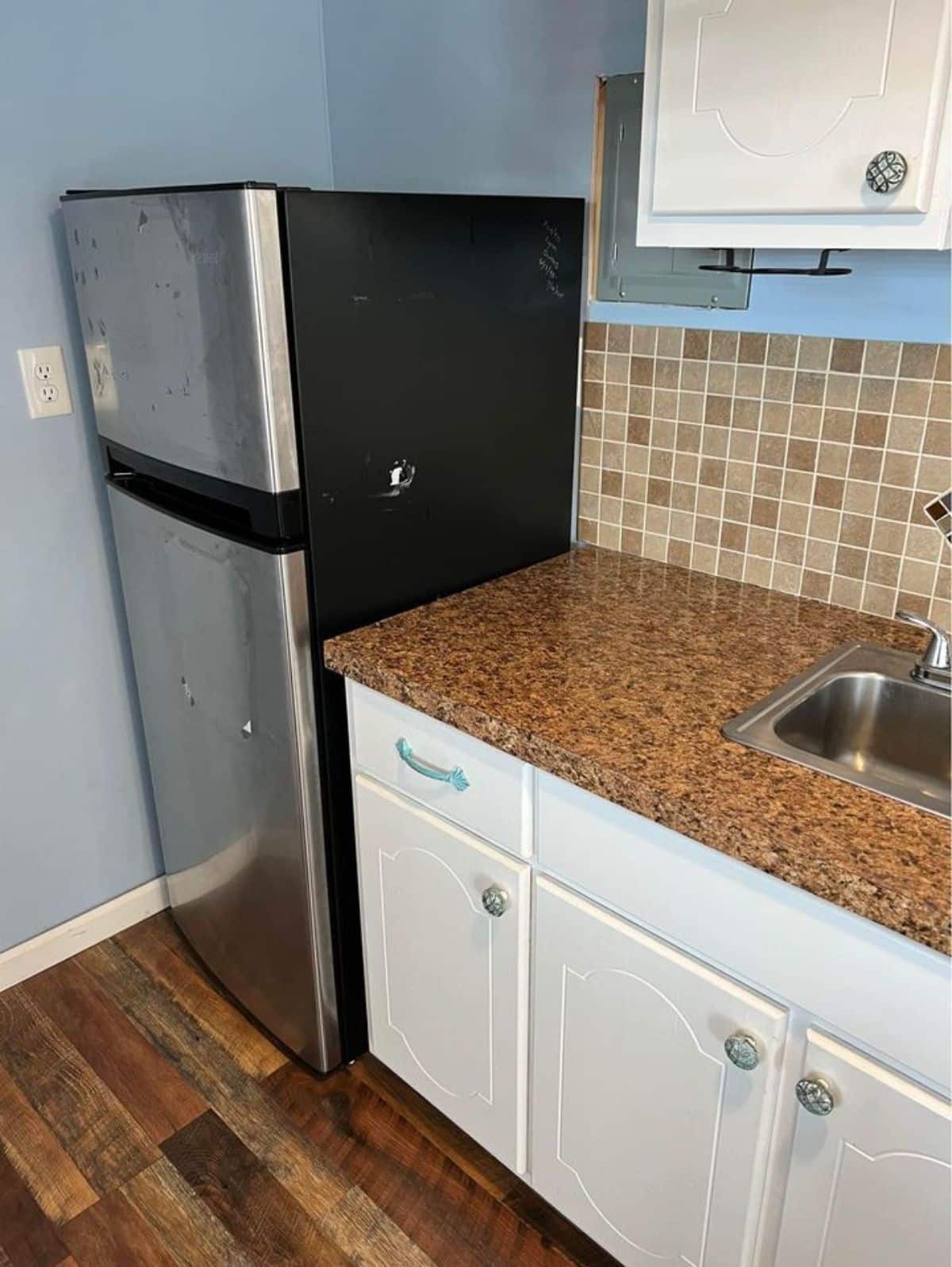 Huge refrigerator in kitchen of 32-footed Shed Tiny Home