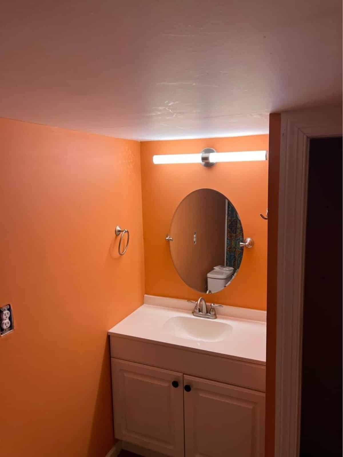 Sink with vanity and mirror in bathroom