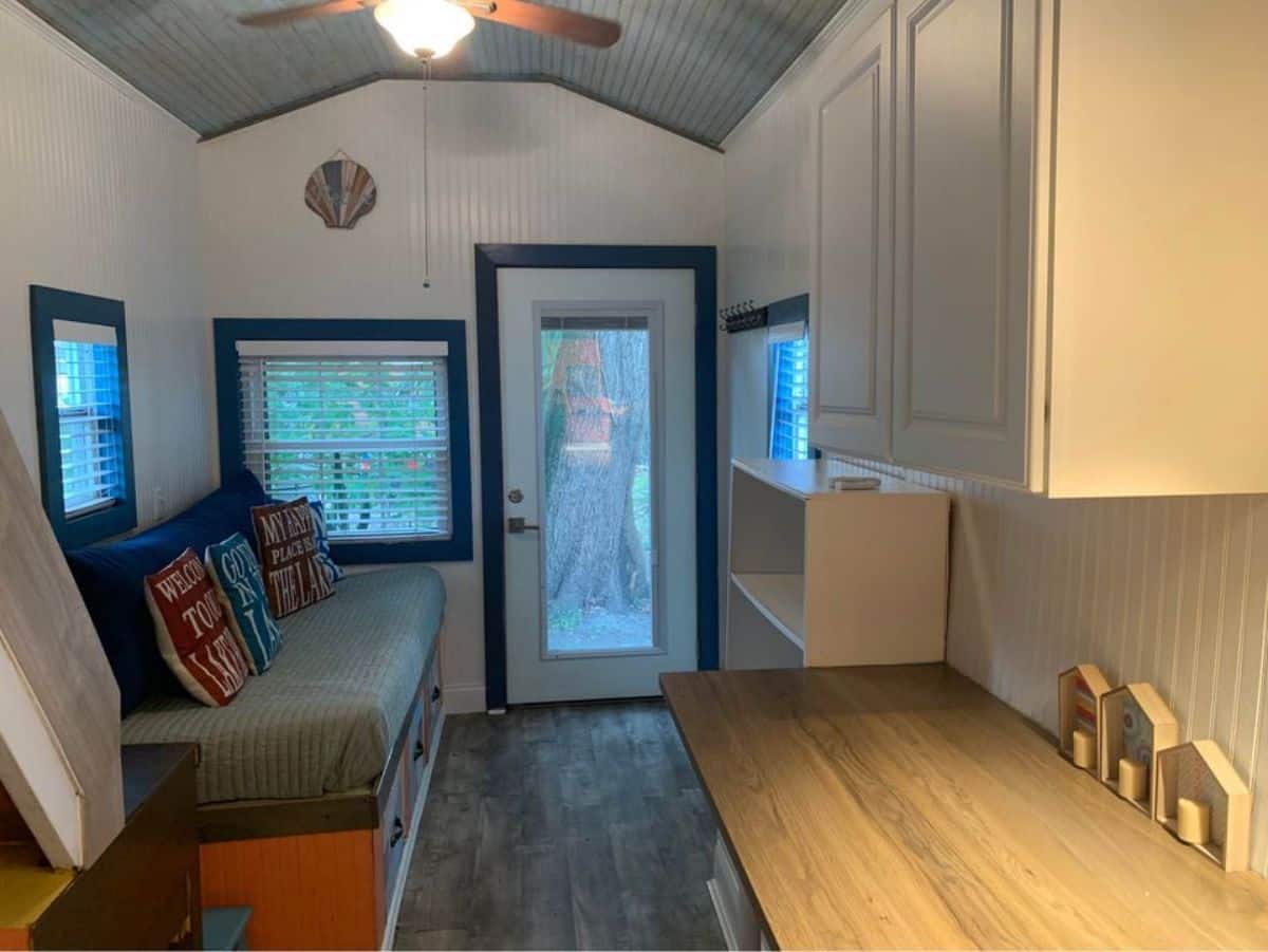 Huge windows right besides the main door of 400 sf tiny home