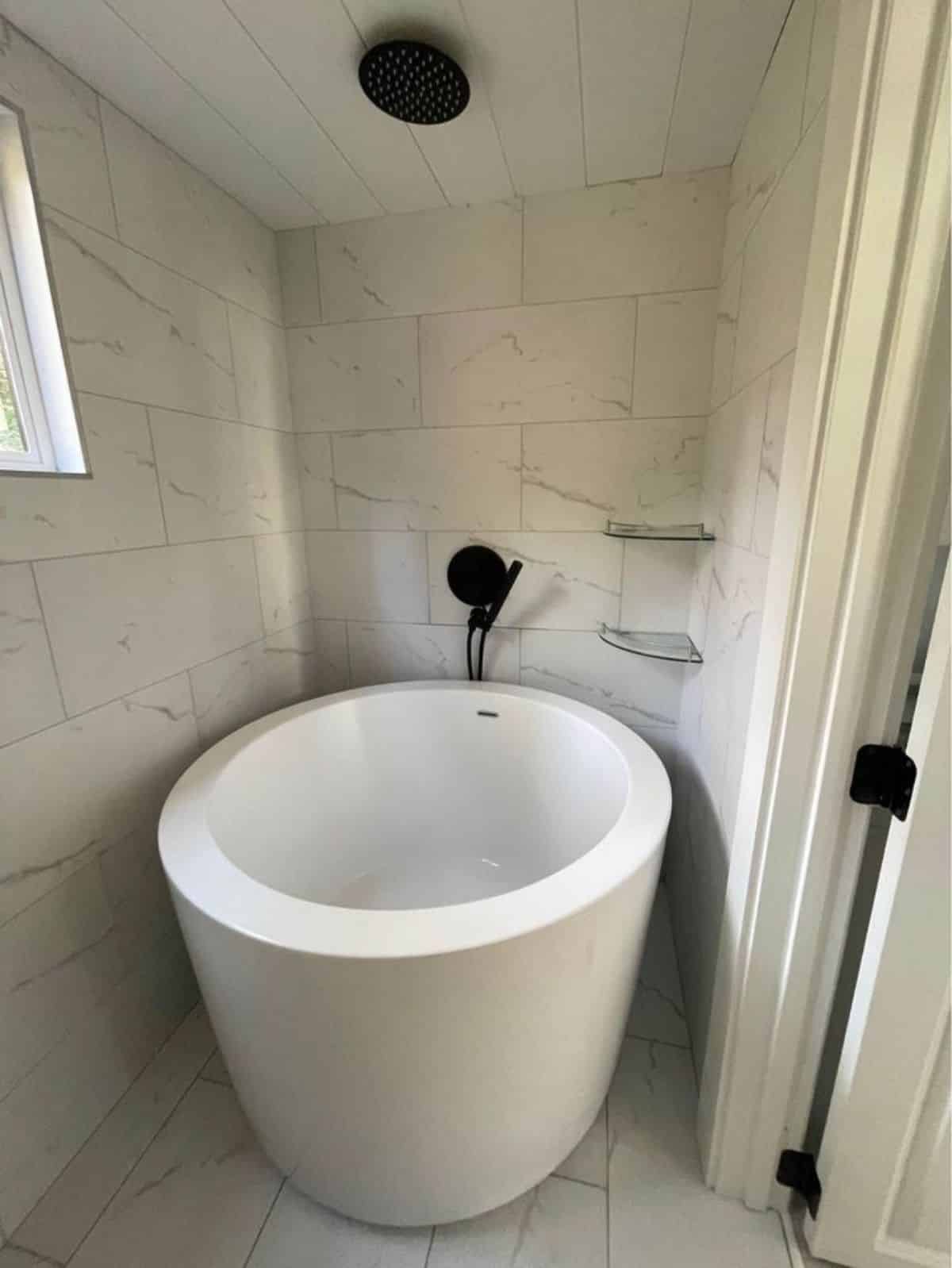Huge bathtub with shower in bathroom