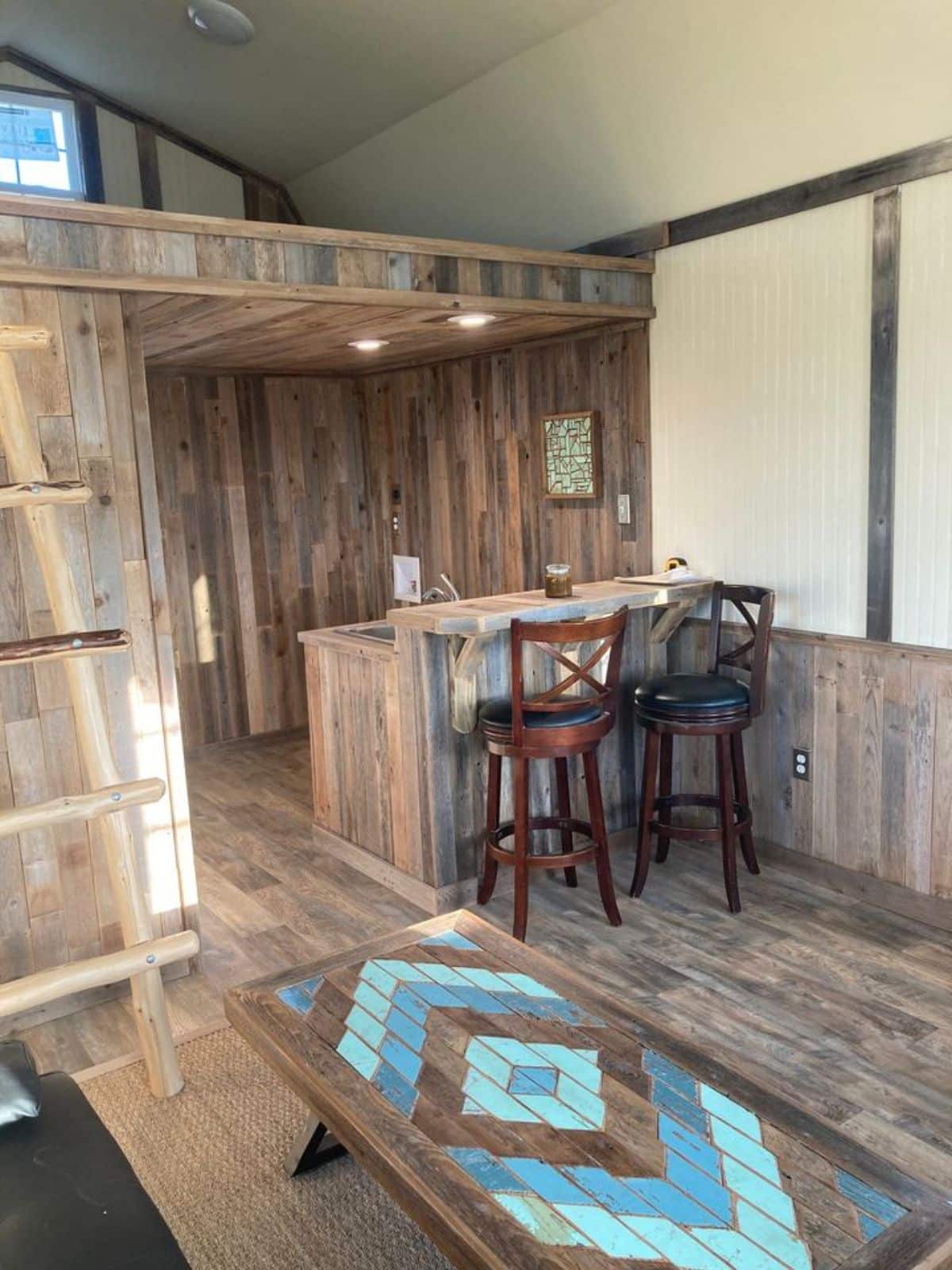 Wooden interiors of double lofted tiny home