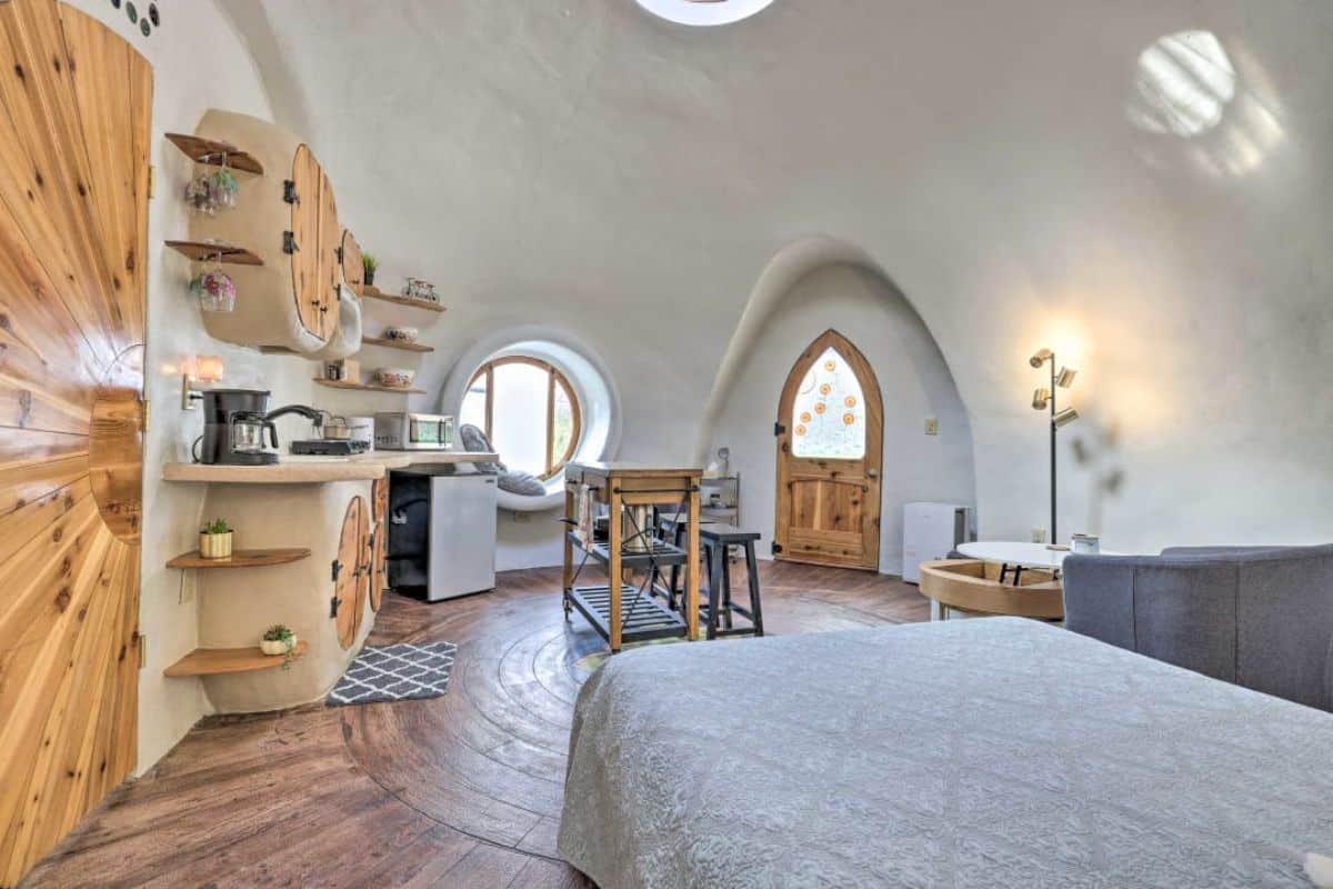 inside earthen home tiny dome with arched wood door