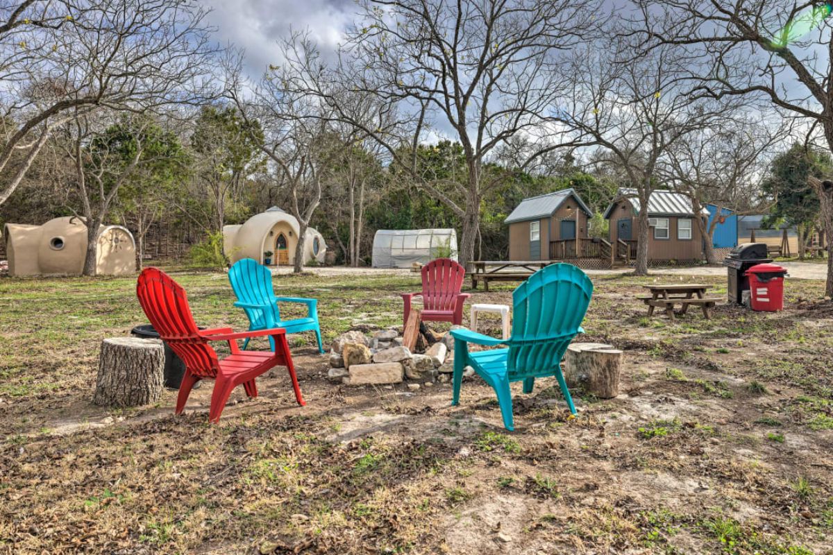 colorful plastic chairs around fire pit