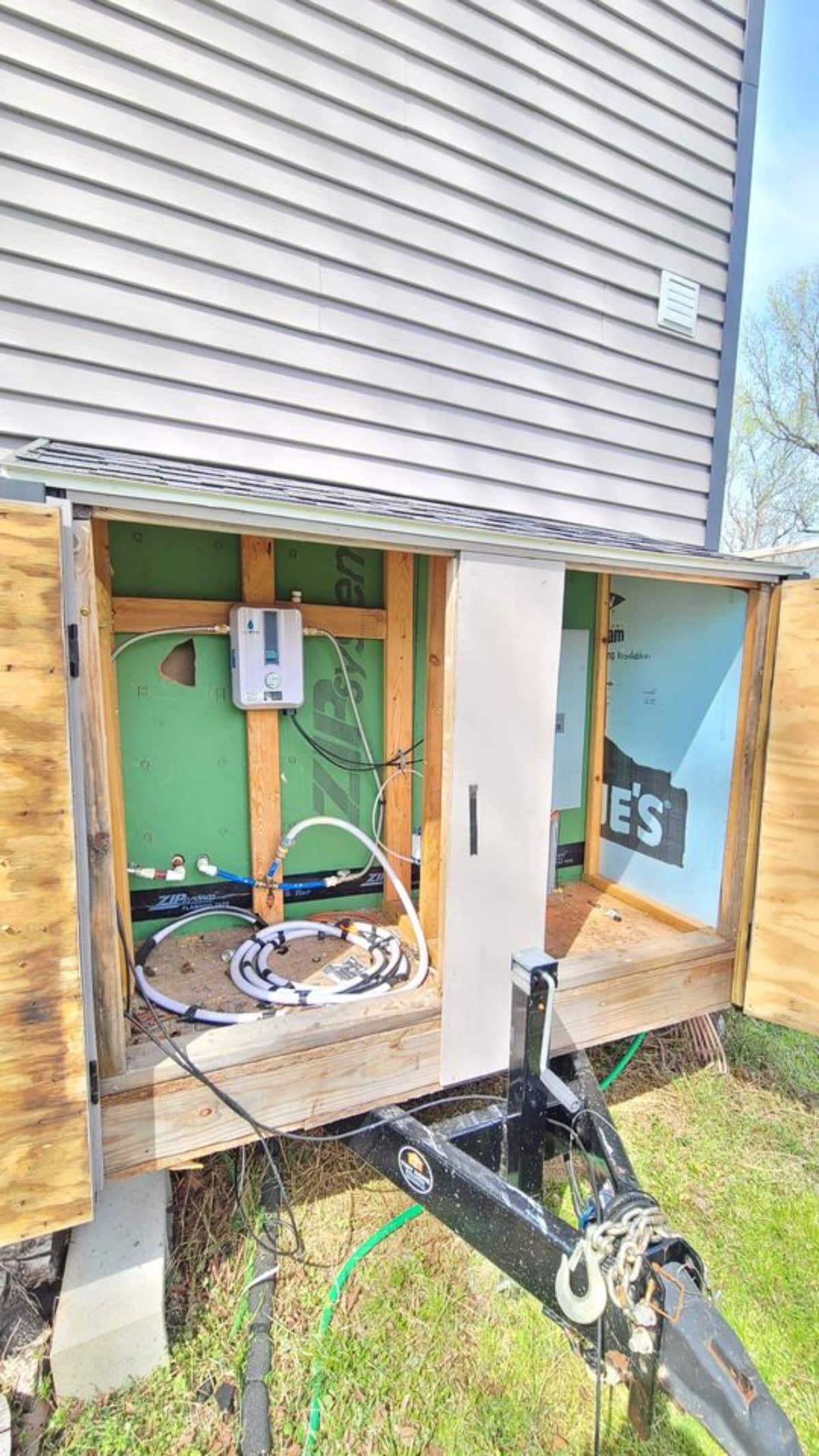 electrical hookups on end of tiny home behind door