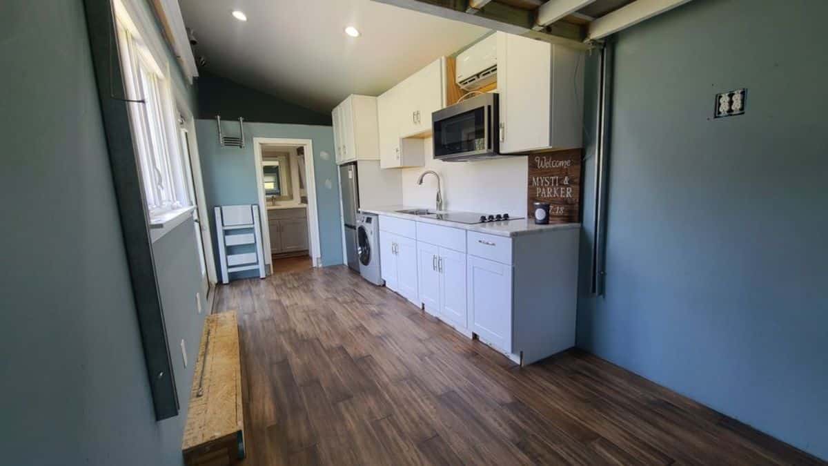 door in background with white cabinets on right
