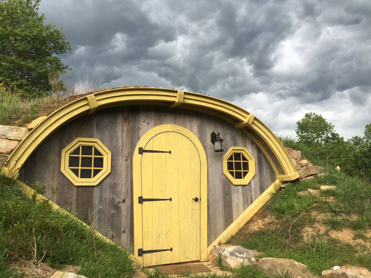 yellow door and trim on front of hobbit hut