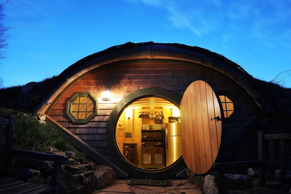 open door to kitchen on hobbit hut with sunset background