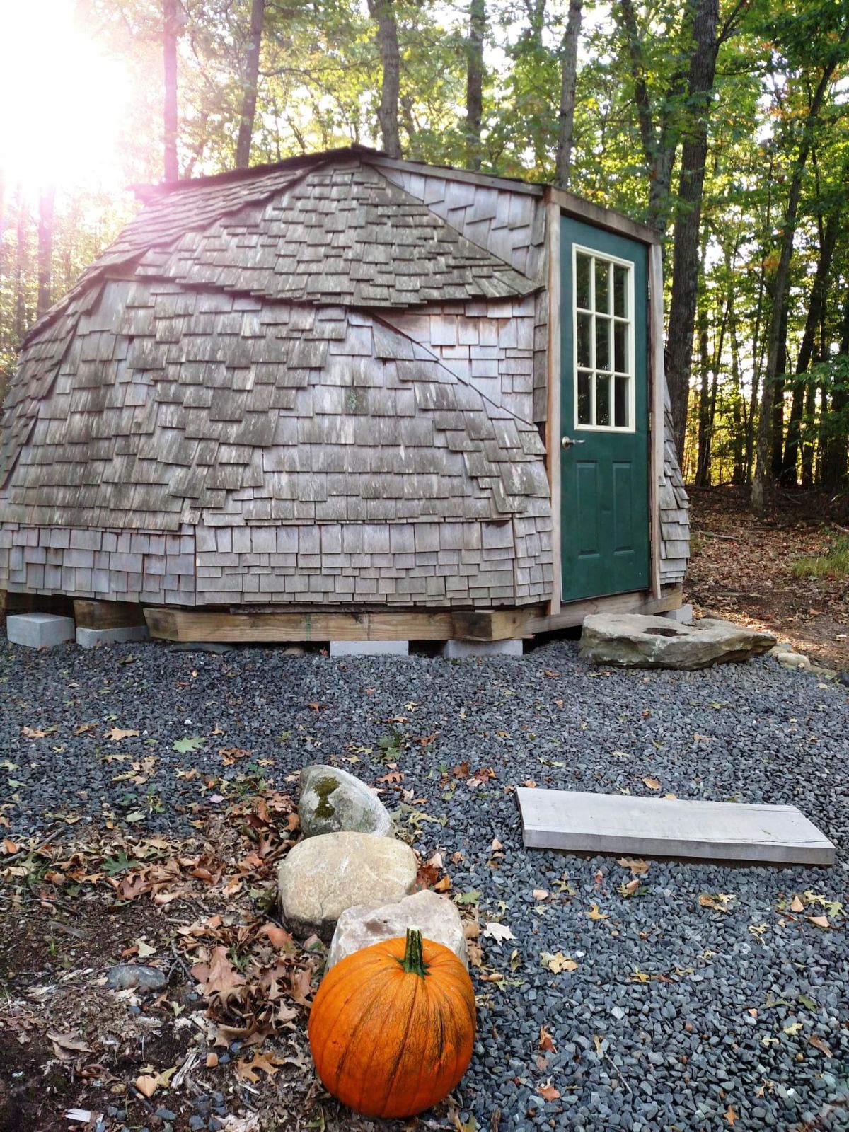 pumpkin decor outside dome rental with green door