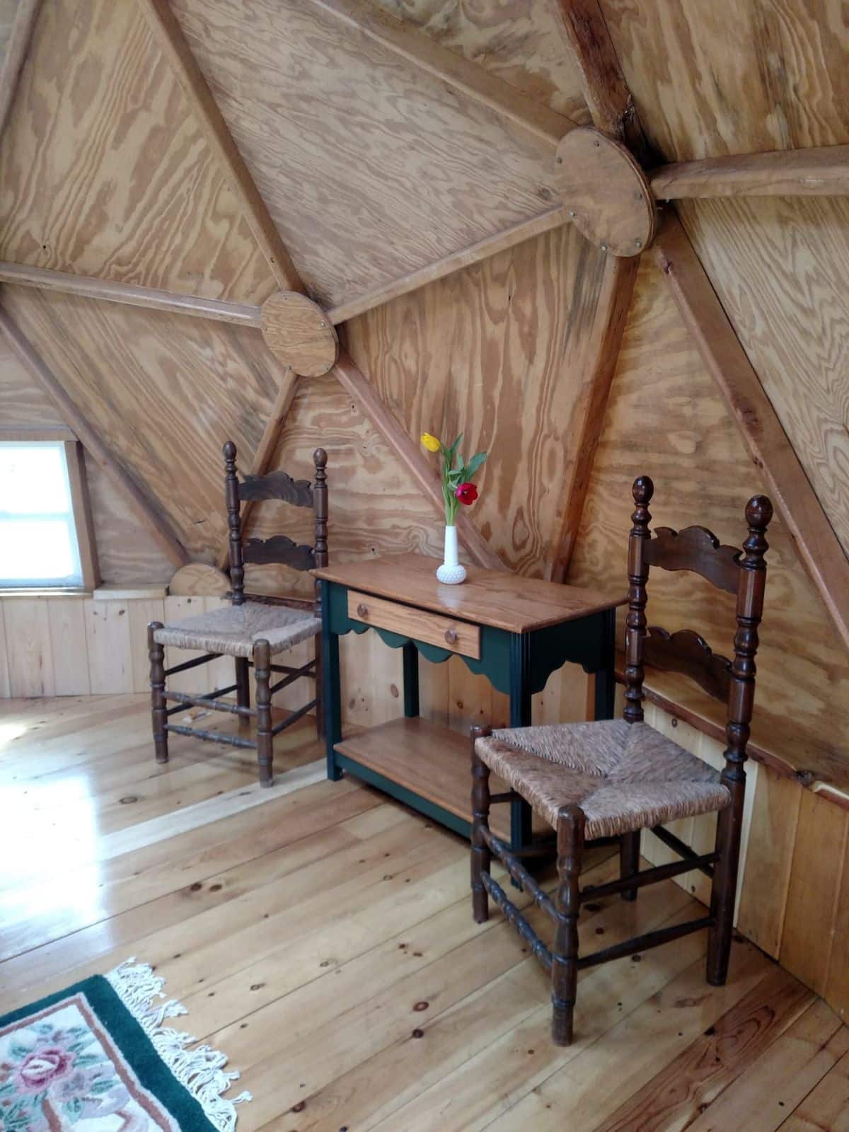 two person wood table with chairs in dome rental