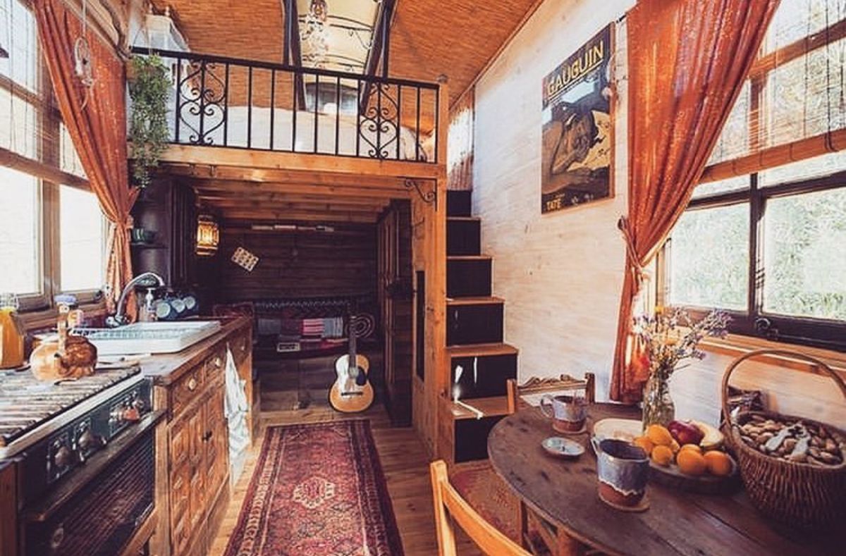 stairs to right and loft above with kitchen on left in tiny home