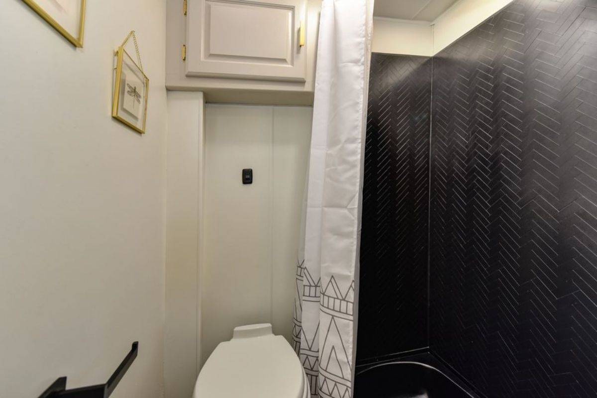 Standard toilet in bathroom of luxury tiny home