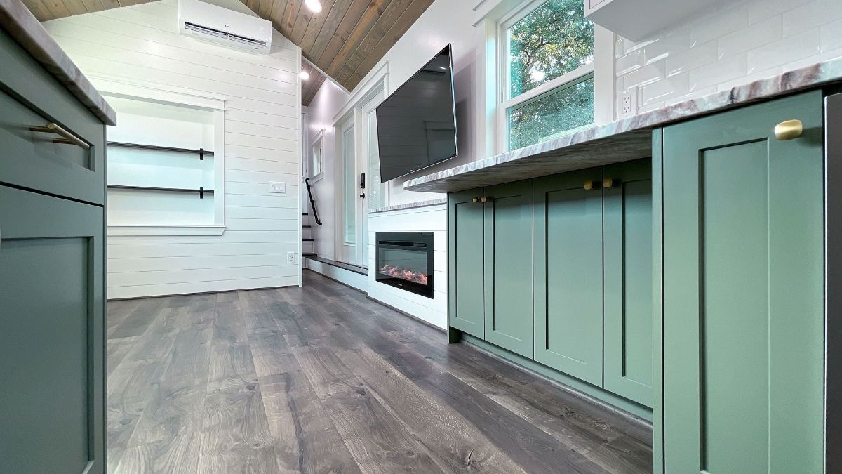 light green cabinets below white marbled counters