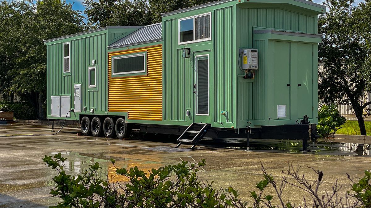 light green tiny home with yellow accents