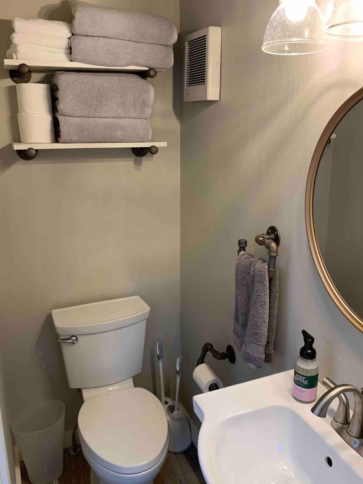 white toilet against gray wall in bathroom