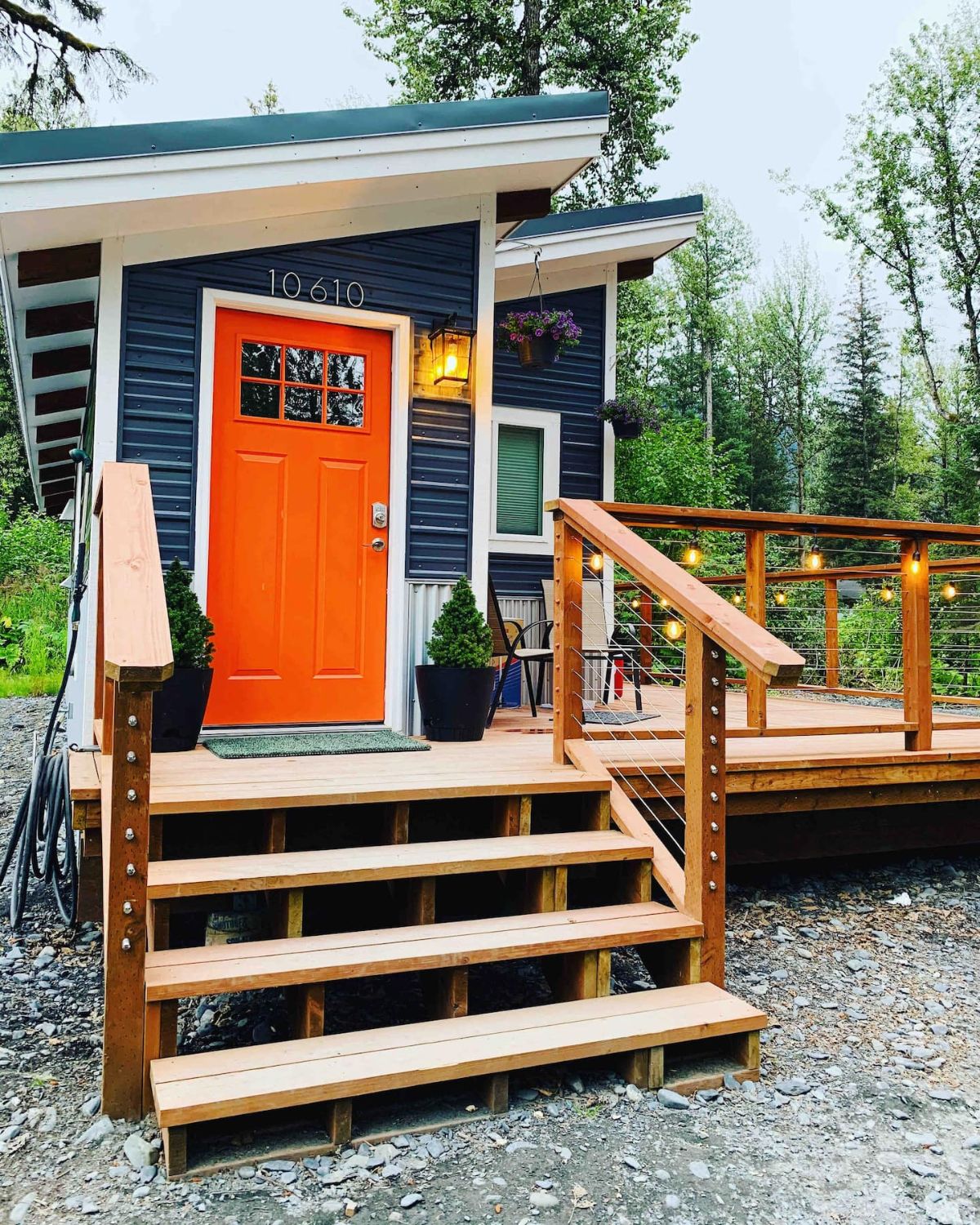 wooden porch on front of tiny home