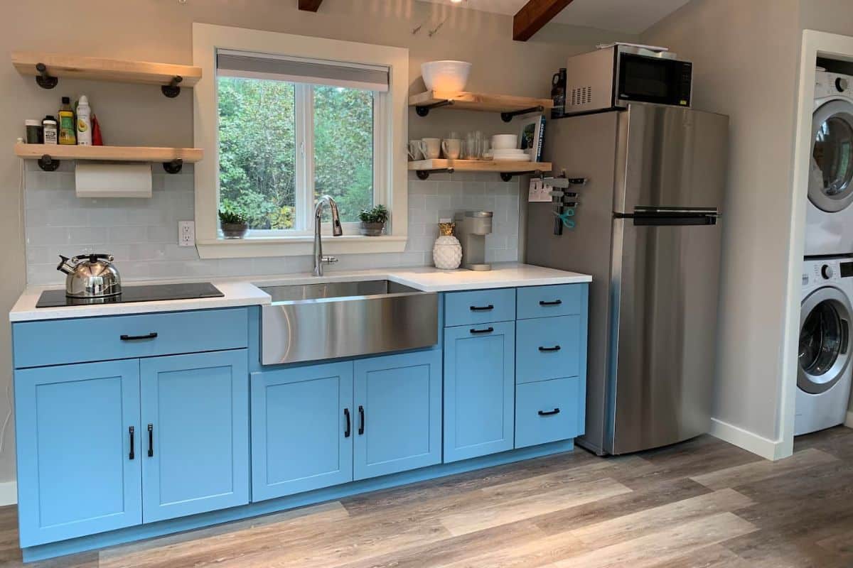 light blue cabinets with stainless steel appliances in kitchen