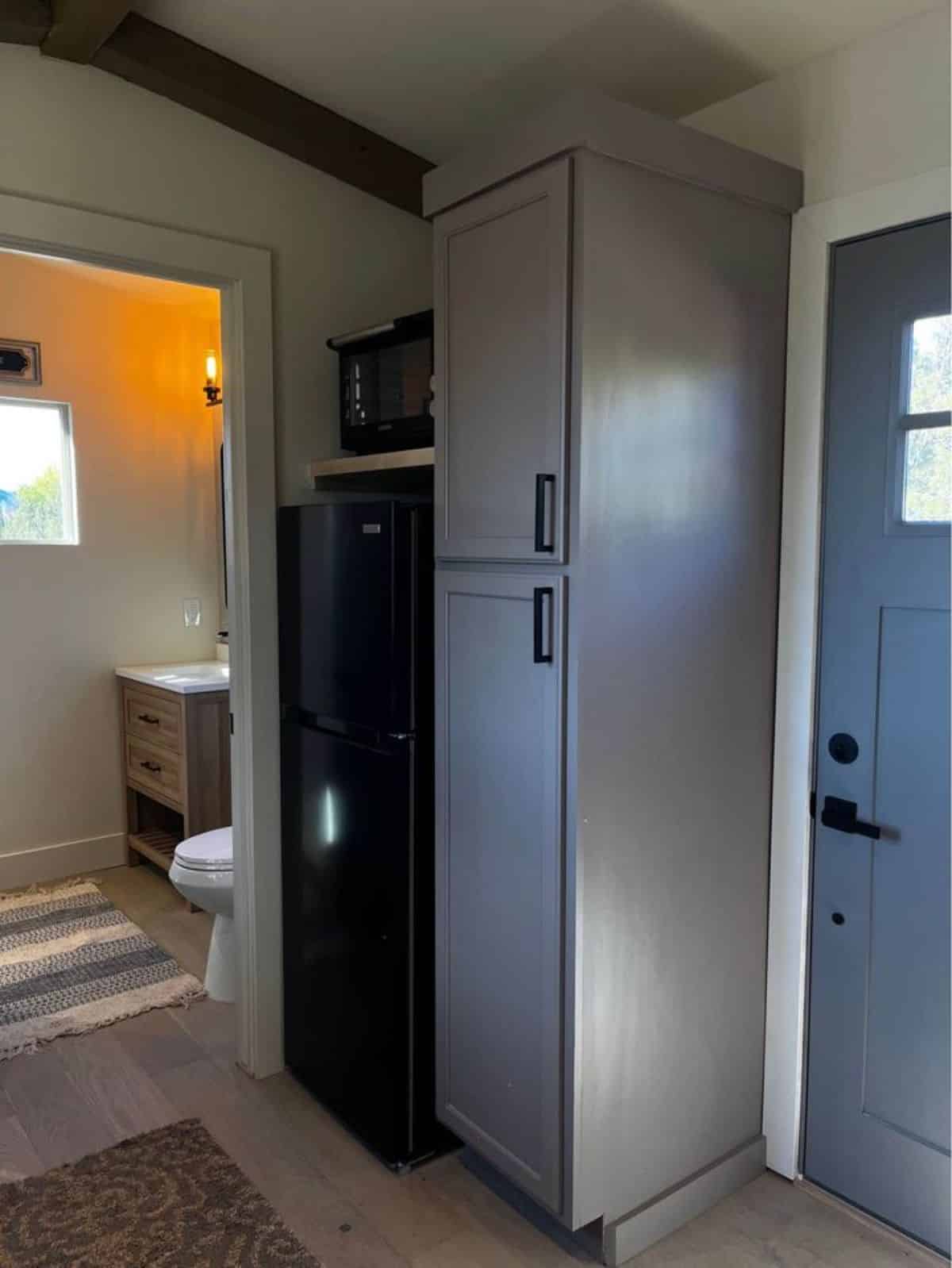 Right when you step inside the house you will find a huge storage cabinets and refrigerator