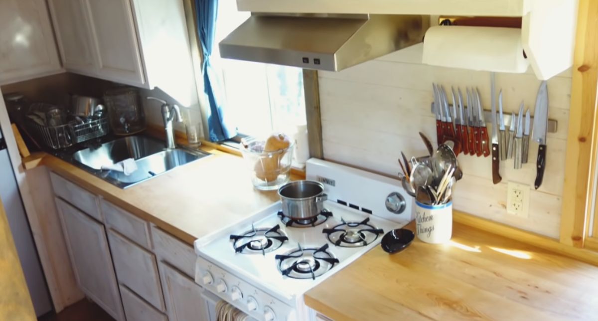 white s4-burner stove in tiny kitchen