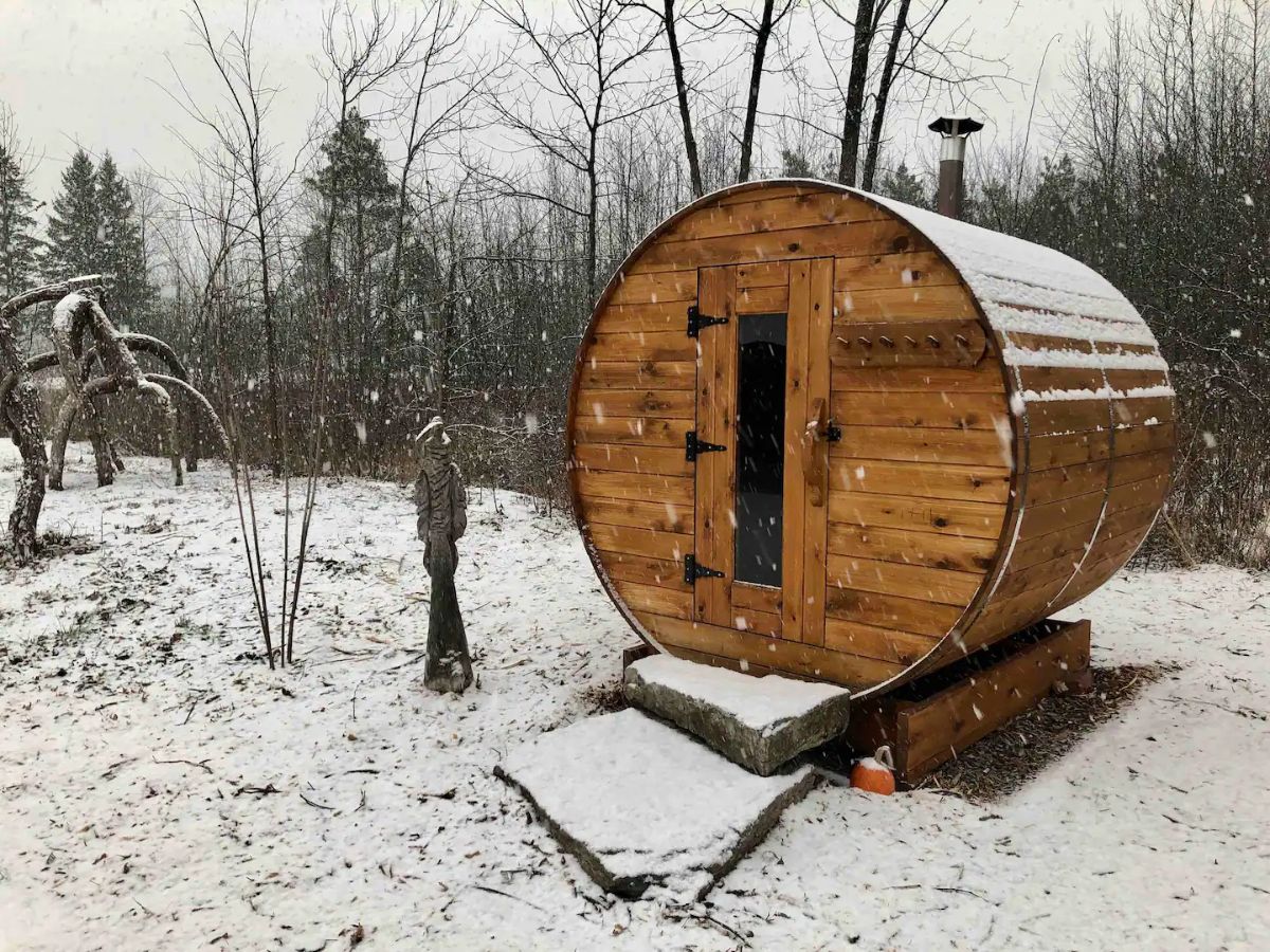 round wood sauna building in snow