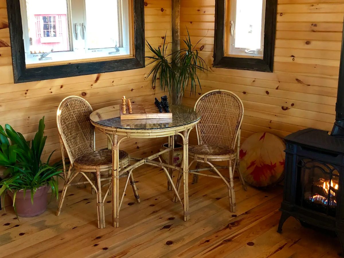 round wood table in corner of cabin