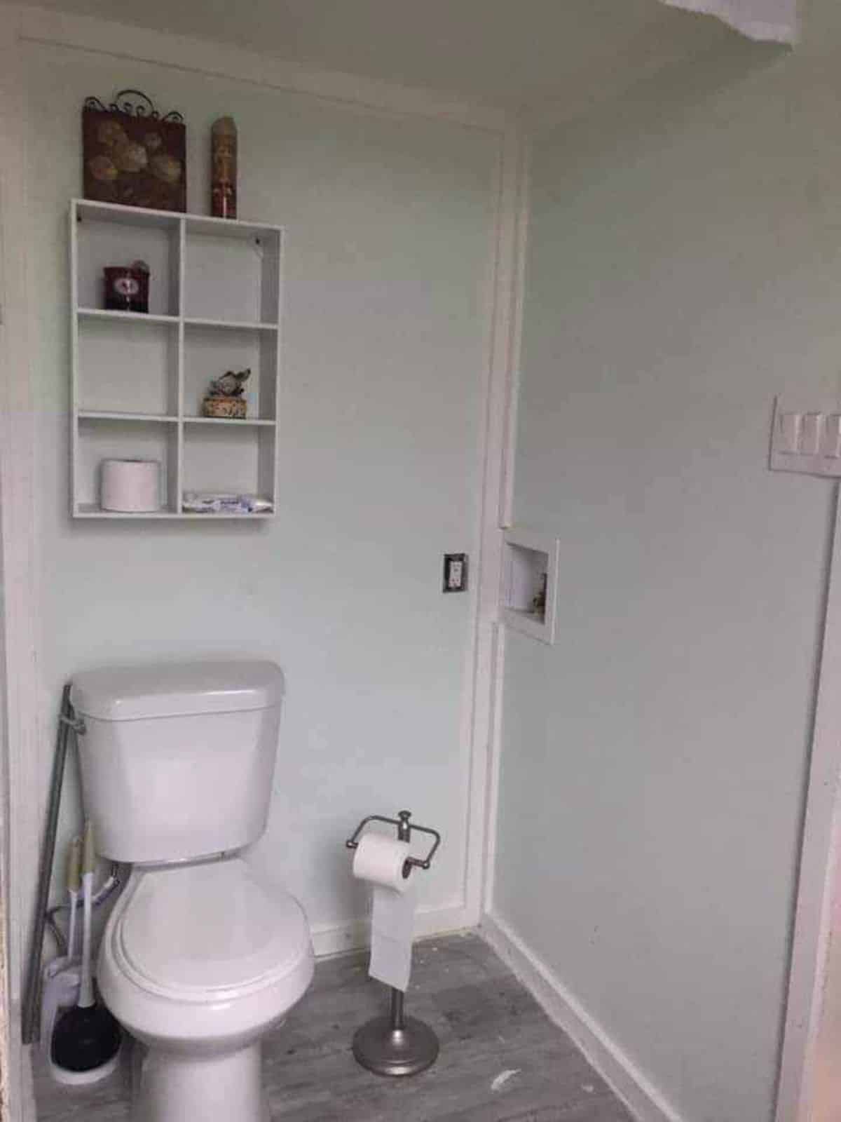 Regular cum composting toilet is installed in the bathroom of Rustic tiny home