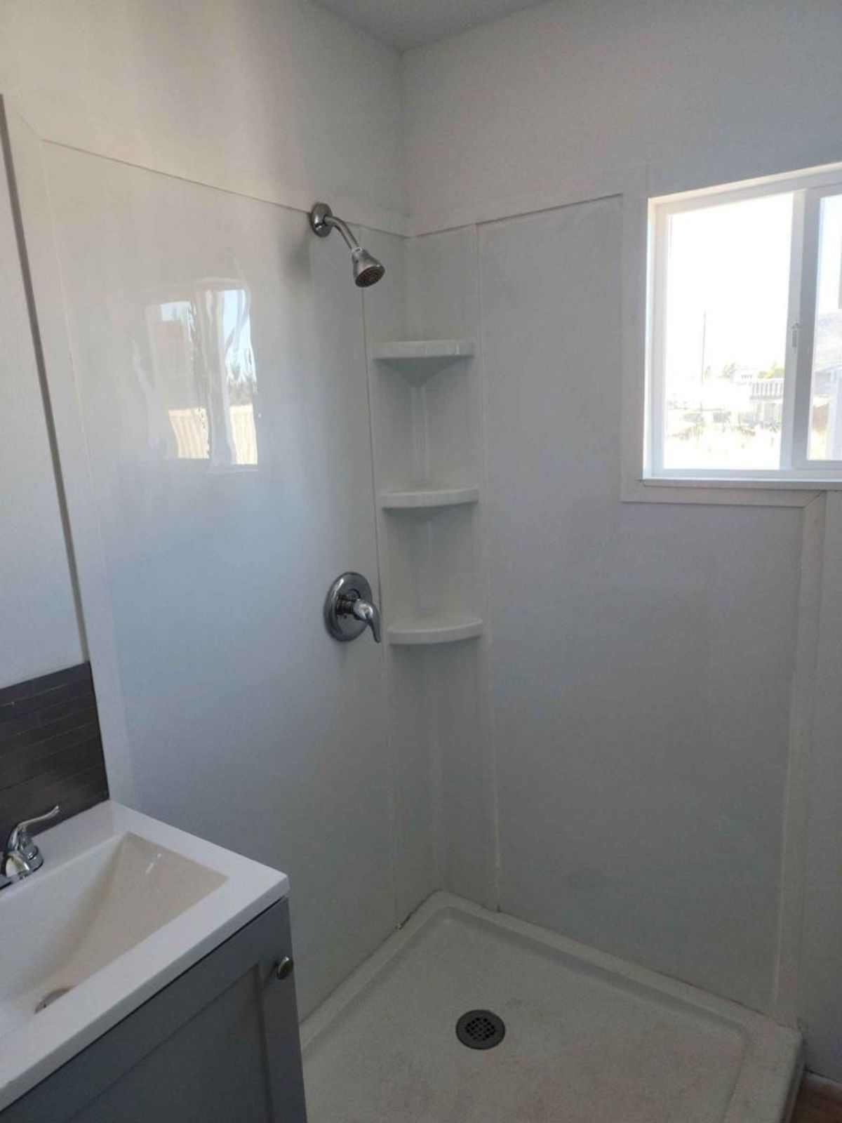 Bathroom of 40' shipping container home is attached to the bedroom makes it a master bedroom