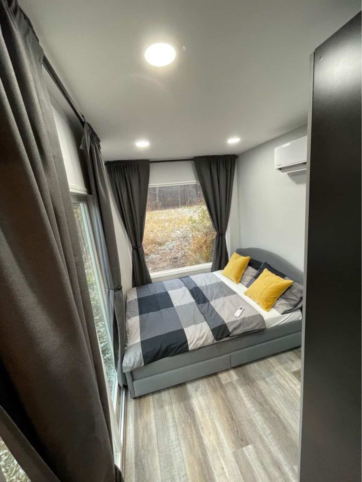 Cozy queen bed in bedroom of Shipping Container House