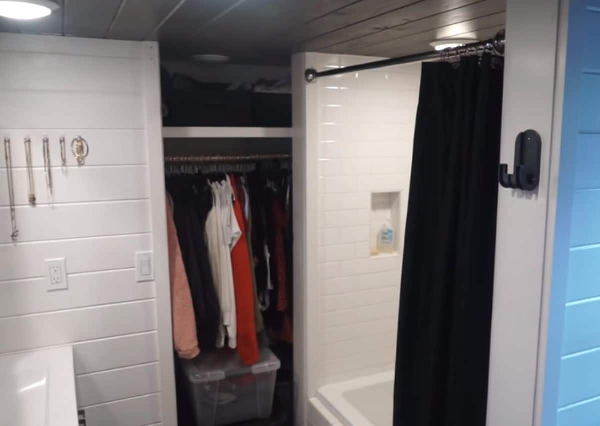 open closet beside white bathtub and shower combination
