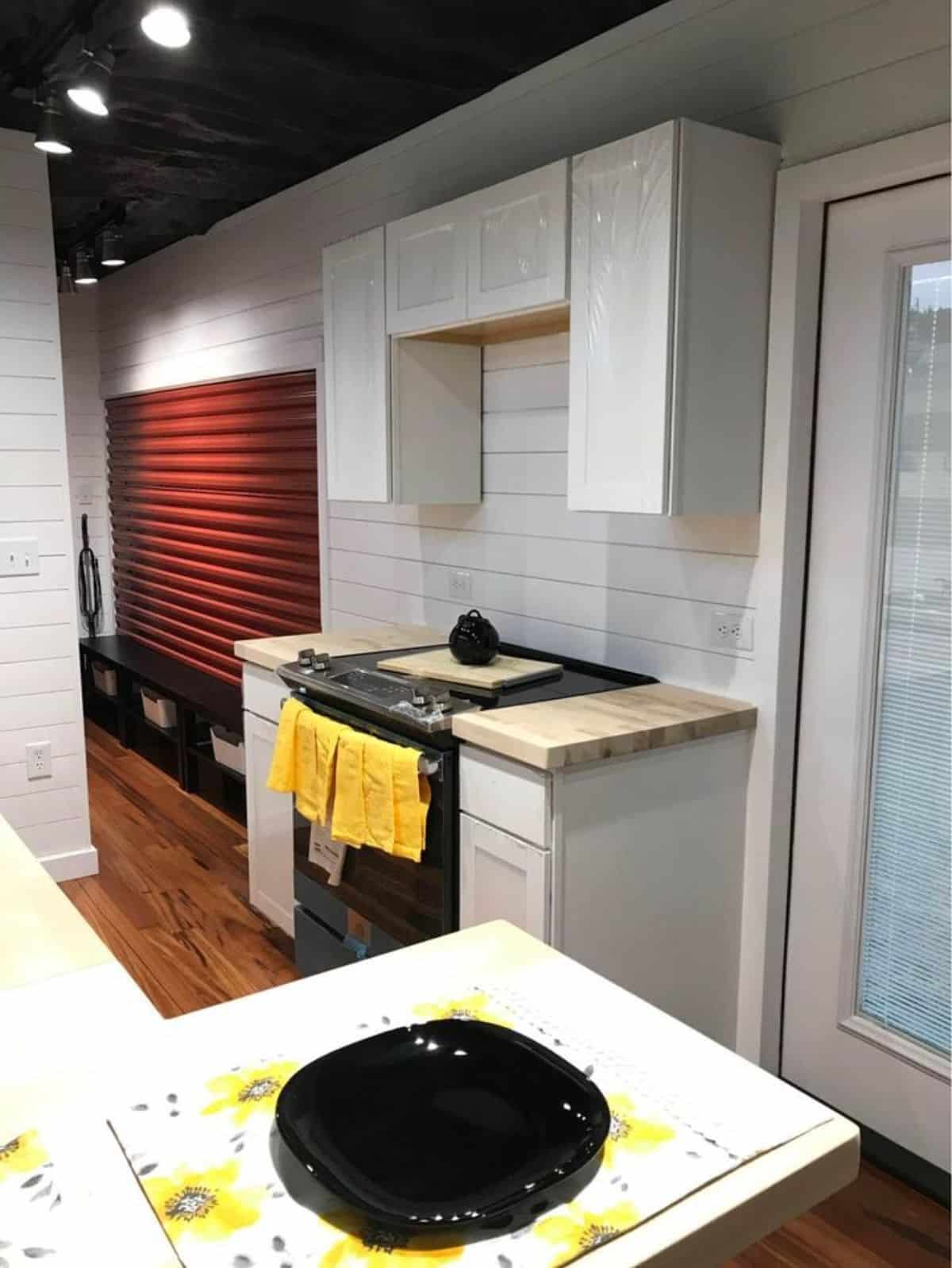 Opposite is cabinets and stove cum oven