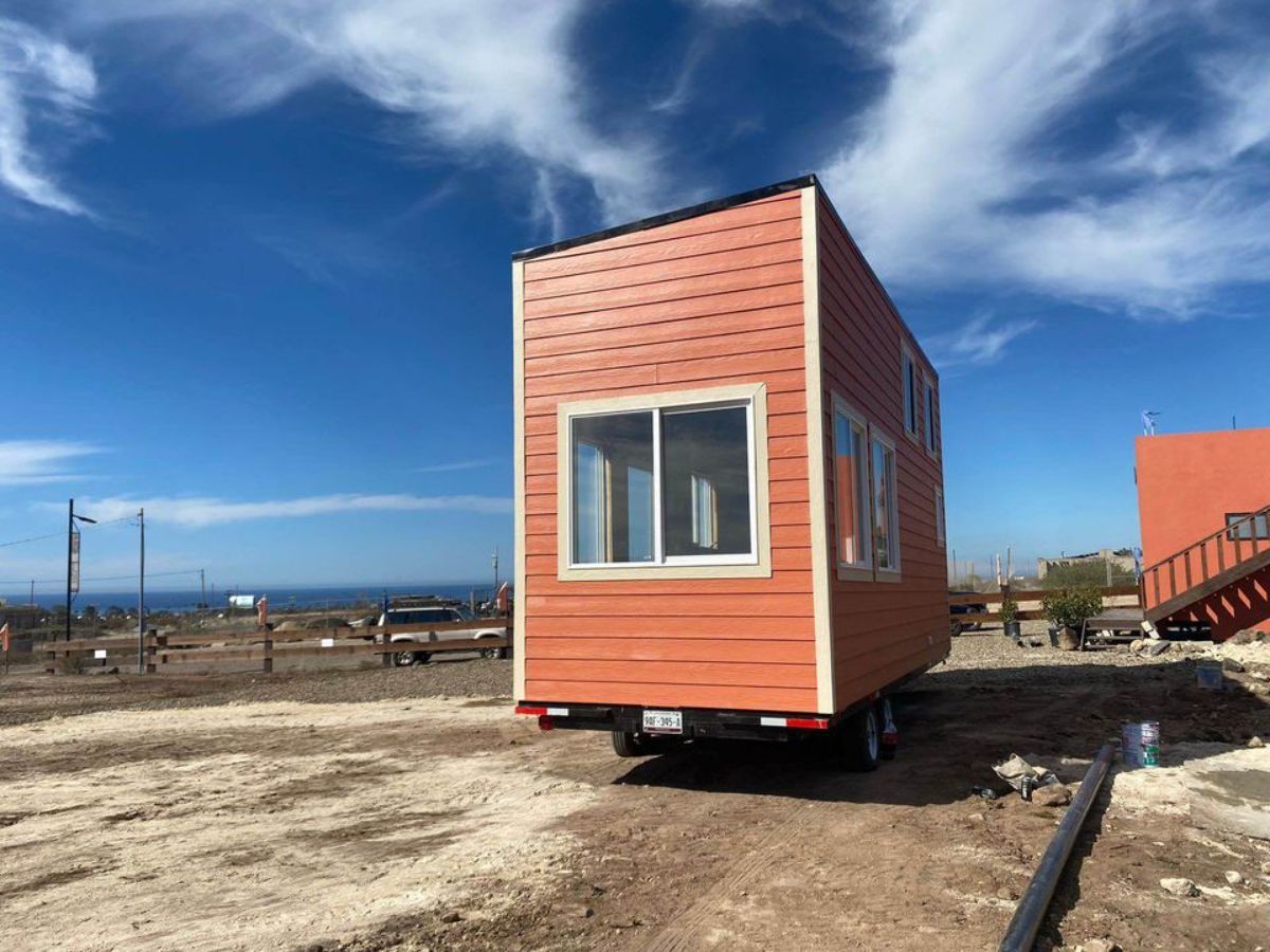 Huge windows all over the sides of gooseneck tiny house