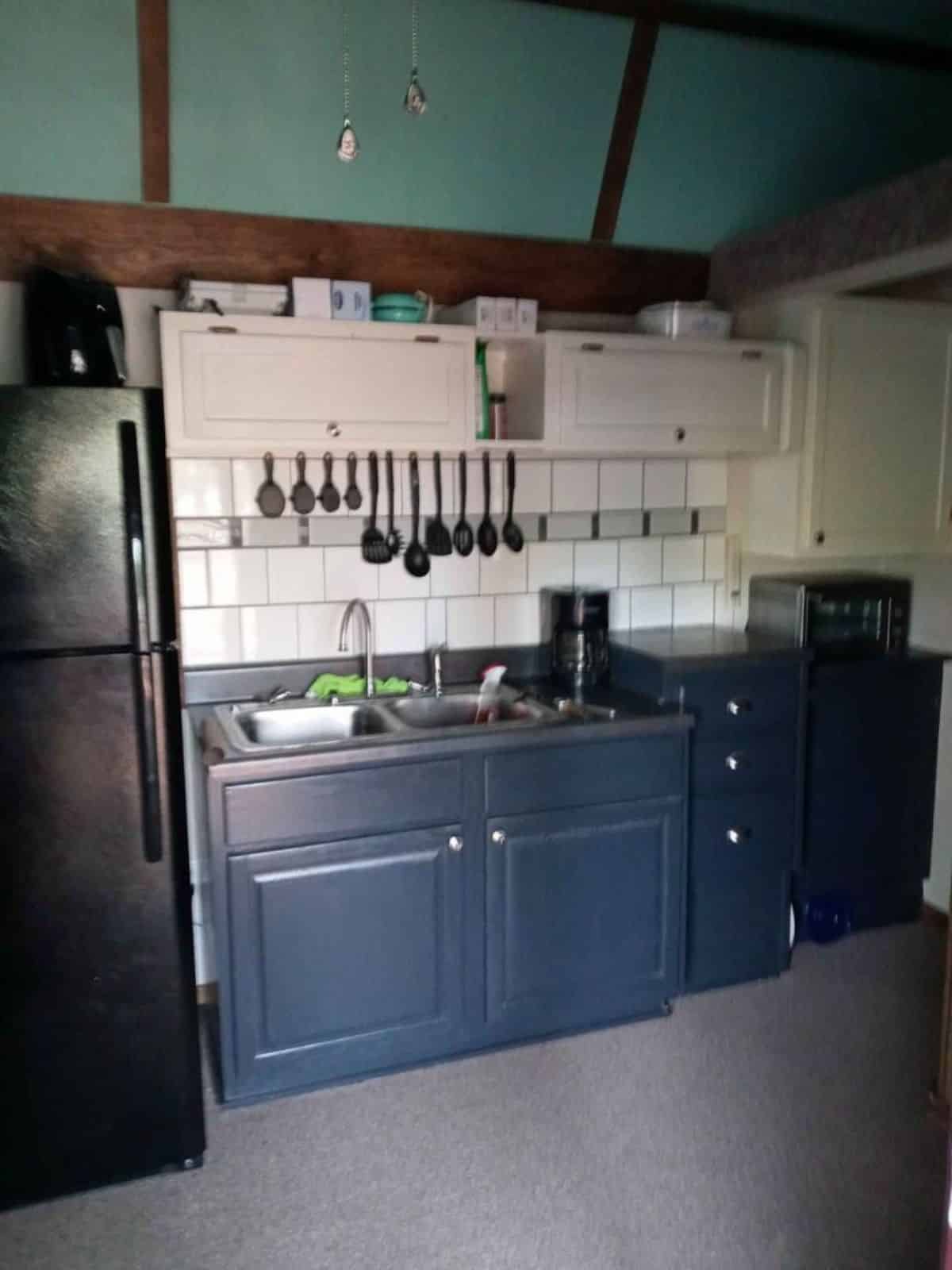 Well organized kitchenette of Tiny Home With Lofts