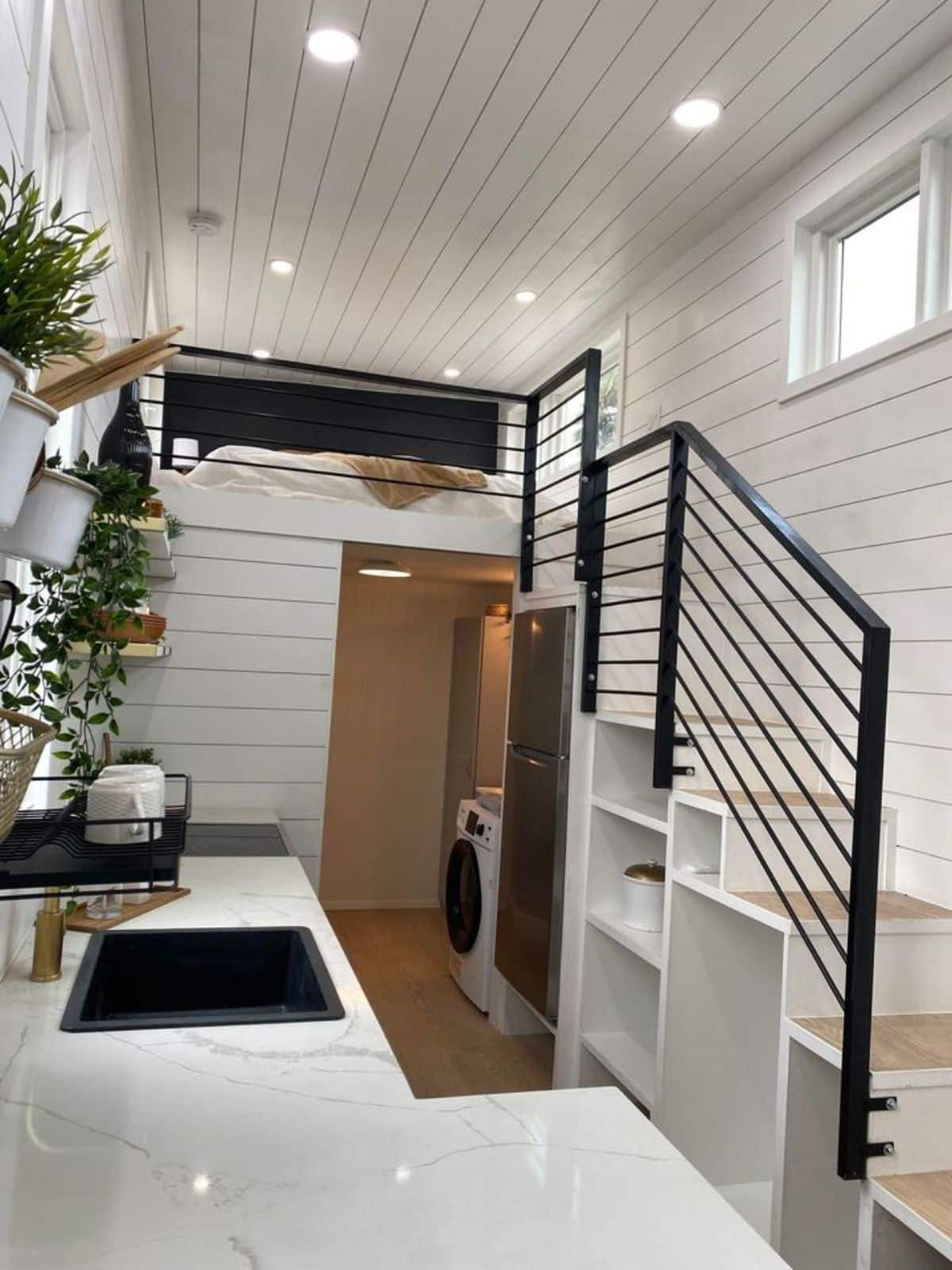 Big loft is accessible via stairs with railings and storage underneath