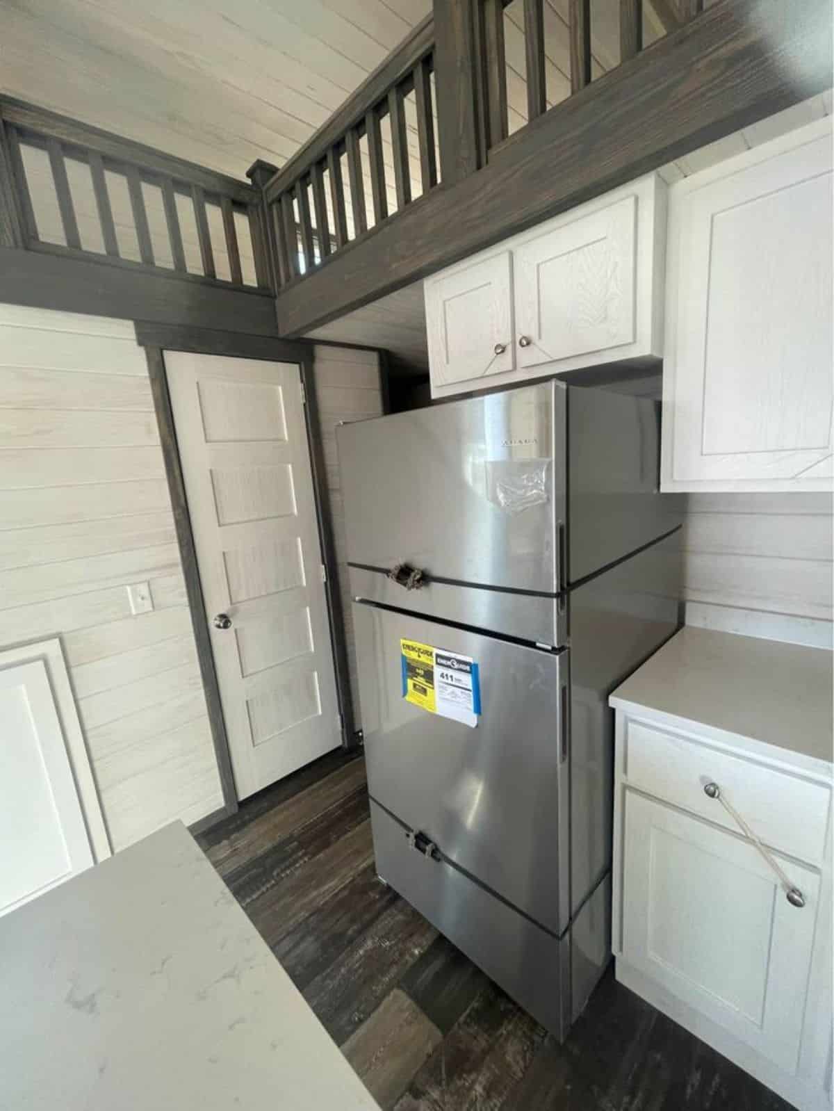 Triple door refrigerator in kitchen area of tiny luxury home