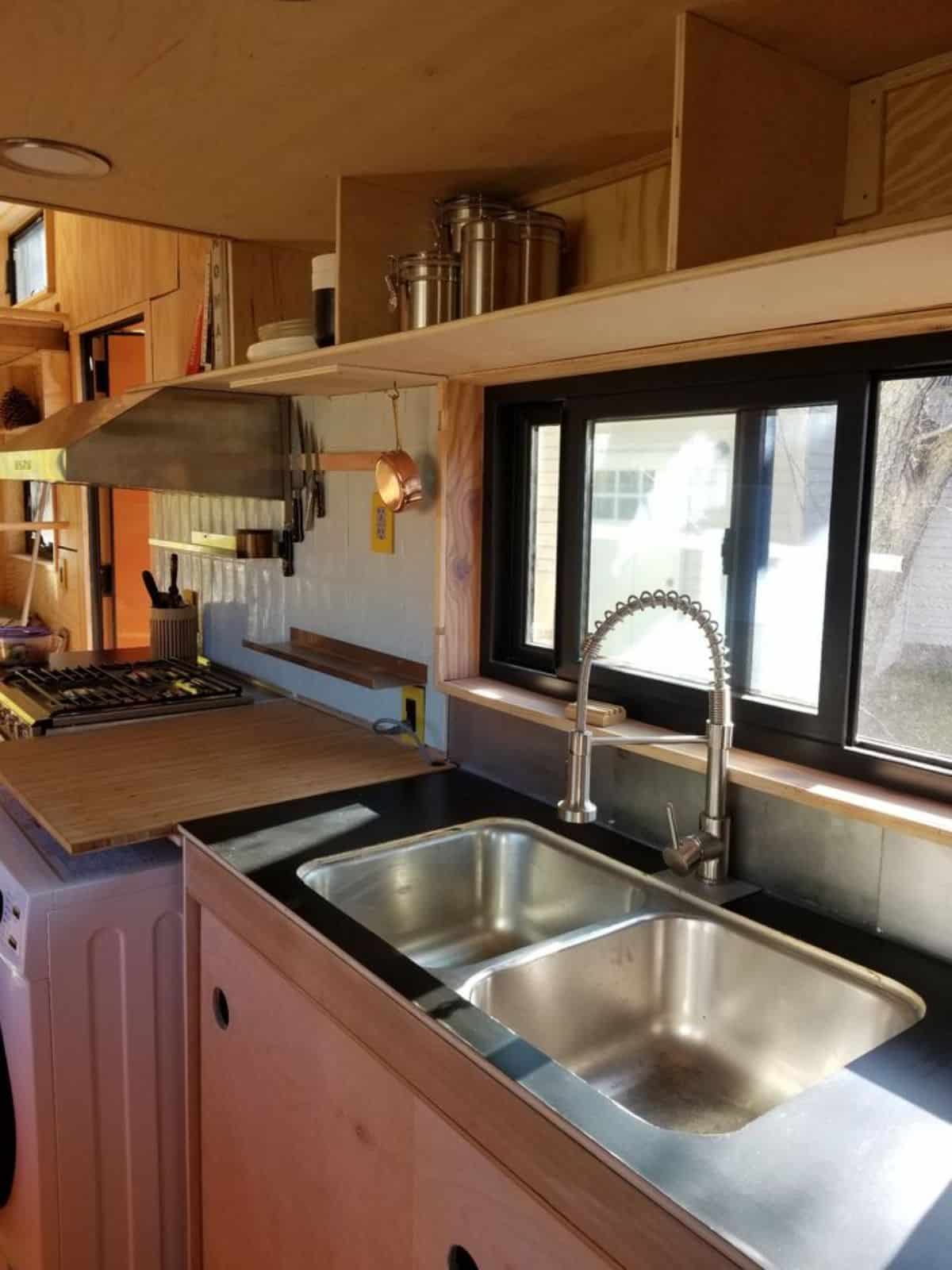 Kitchen area is well organized with burner, sink, storage cabinets