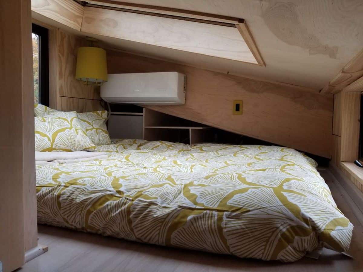 Sleeping area has a queen size mattress plus storage shelves