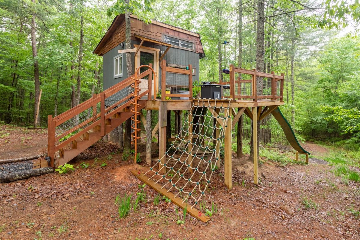 tiny treehouse with rope ladder on side