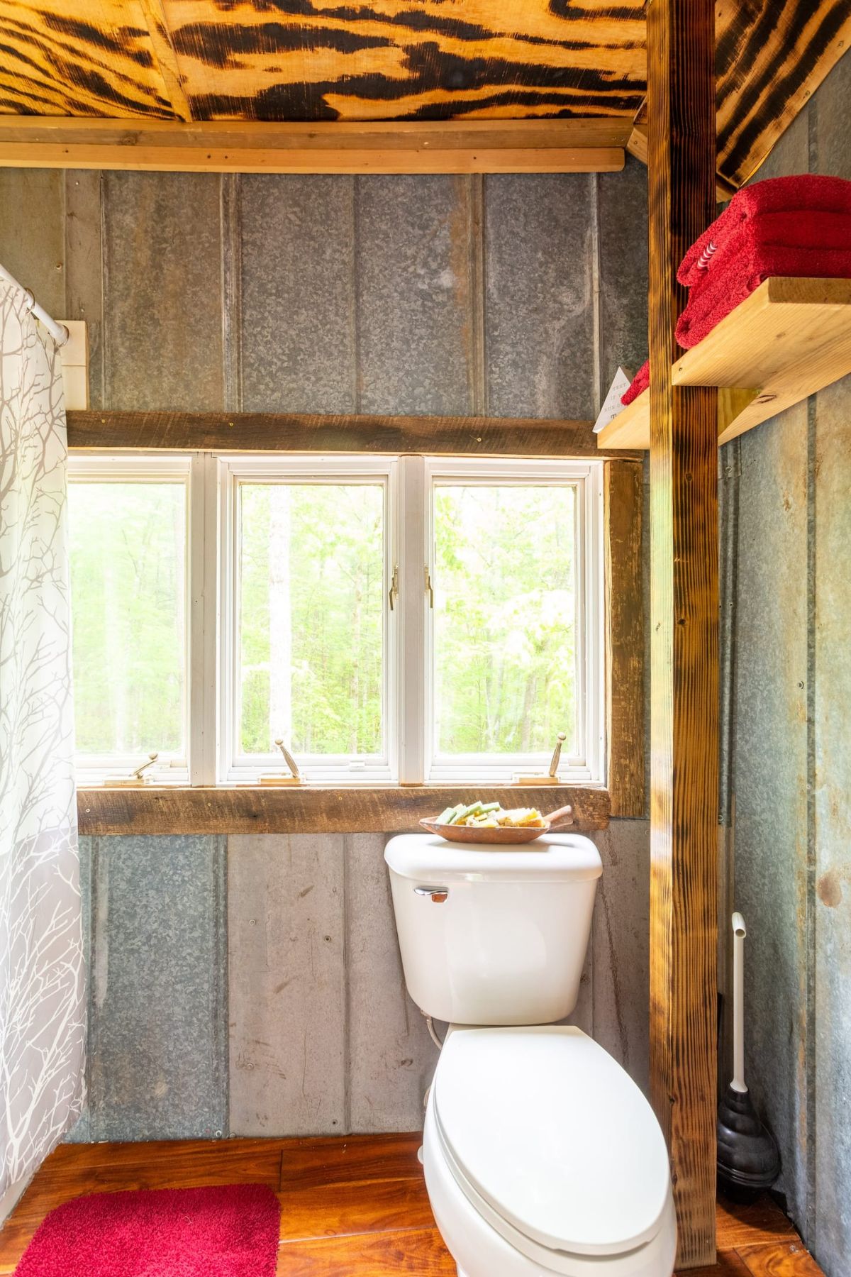 white toilet against reclaimed wood wall