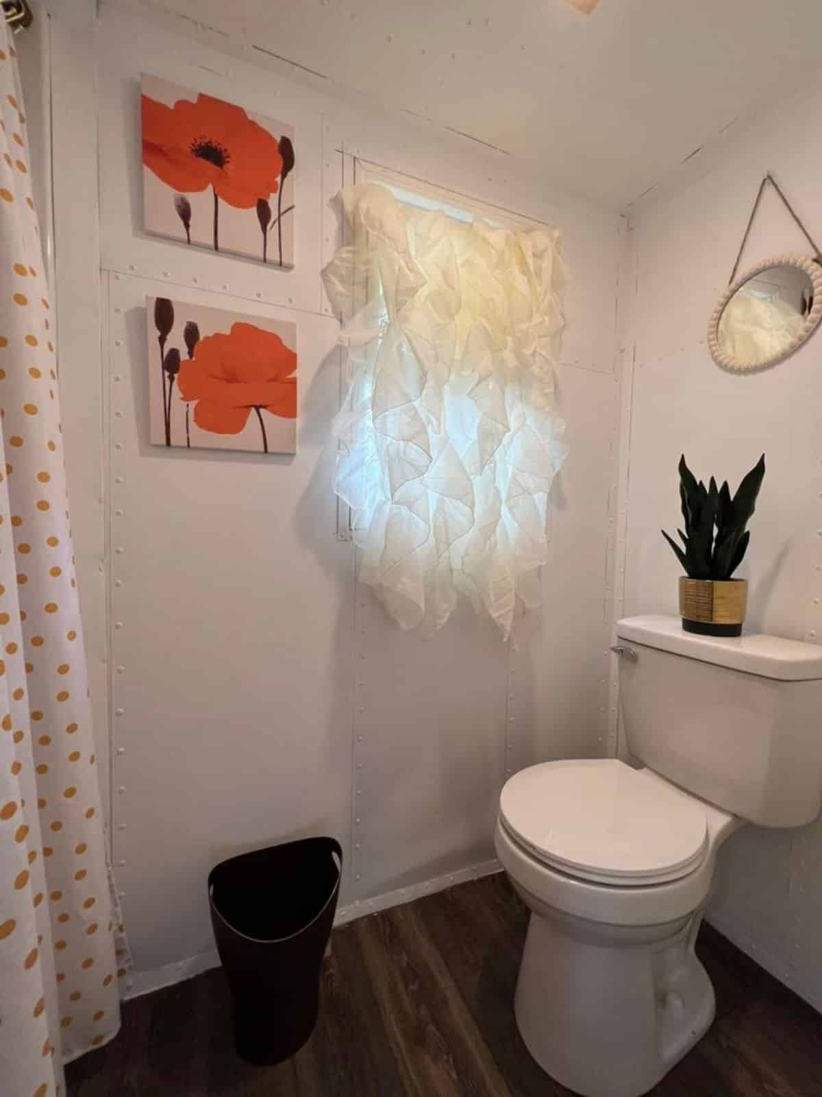bathroom of towable tiny home has a standard toilet