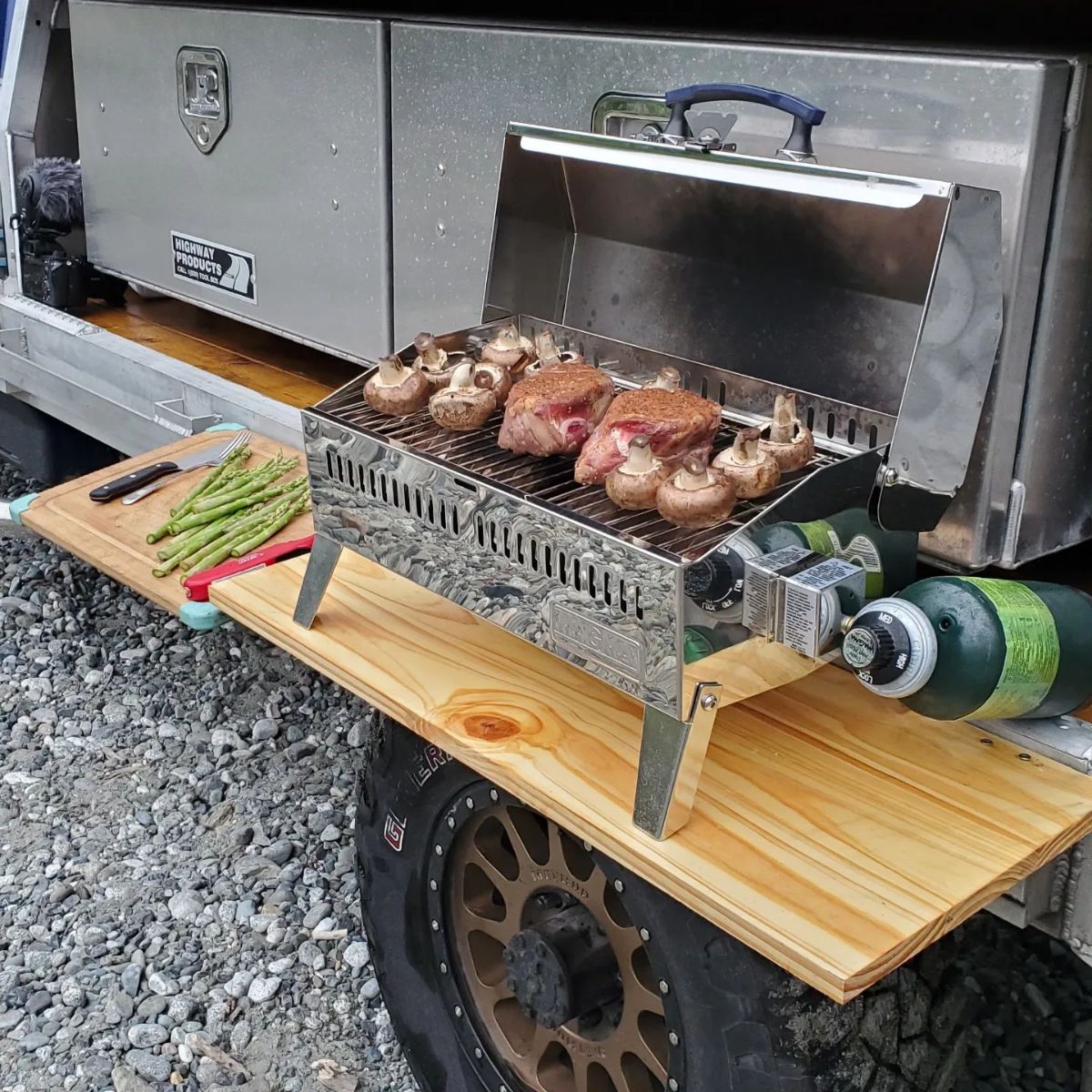grill on wooden shelf on back of tiny house truck