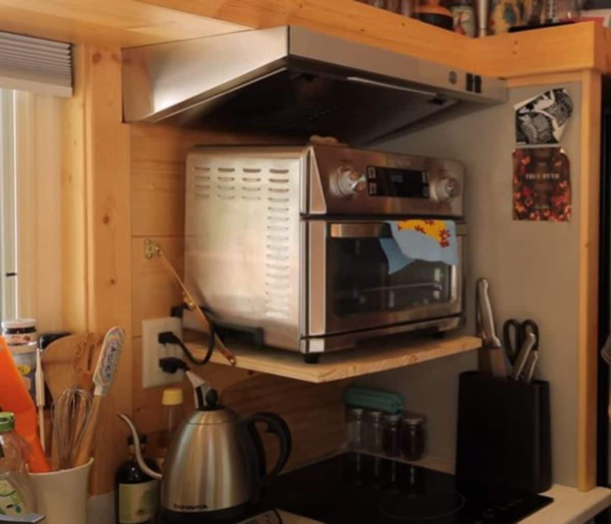 convection oven on shelf above cooktop