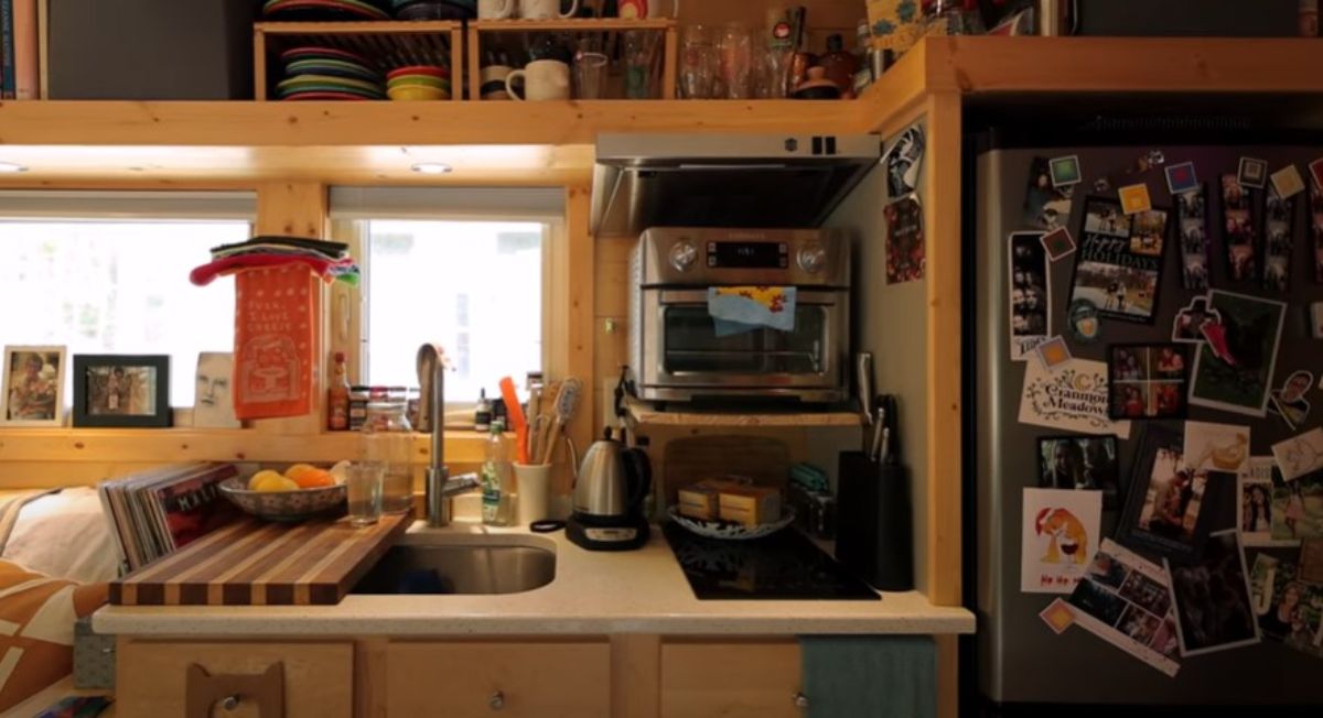 kitchen: pine slats on ceilings and walls, 2 burner cooktop, large sink, refrigerator